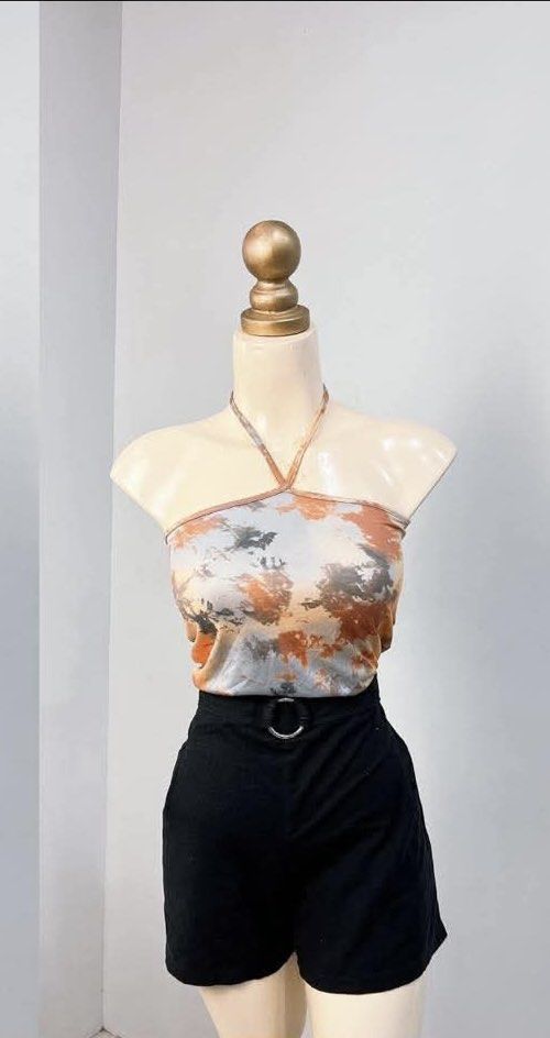 Tie Dye Halter Top with Black Shorts (Category: Sets or Coordinates) located in Bulacan. Submitted by kkaye_ (Listing ID 1420262797, Image 1). Description: Set includes a tie-dye halter top and black shorts. The top features a unique tie-dye pattern with shades of orange, gray, and white. The shorts are high-waisted with a belt loop and a silver buckle. This outfit is perfect for a casual day out or a summer event..