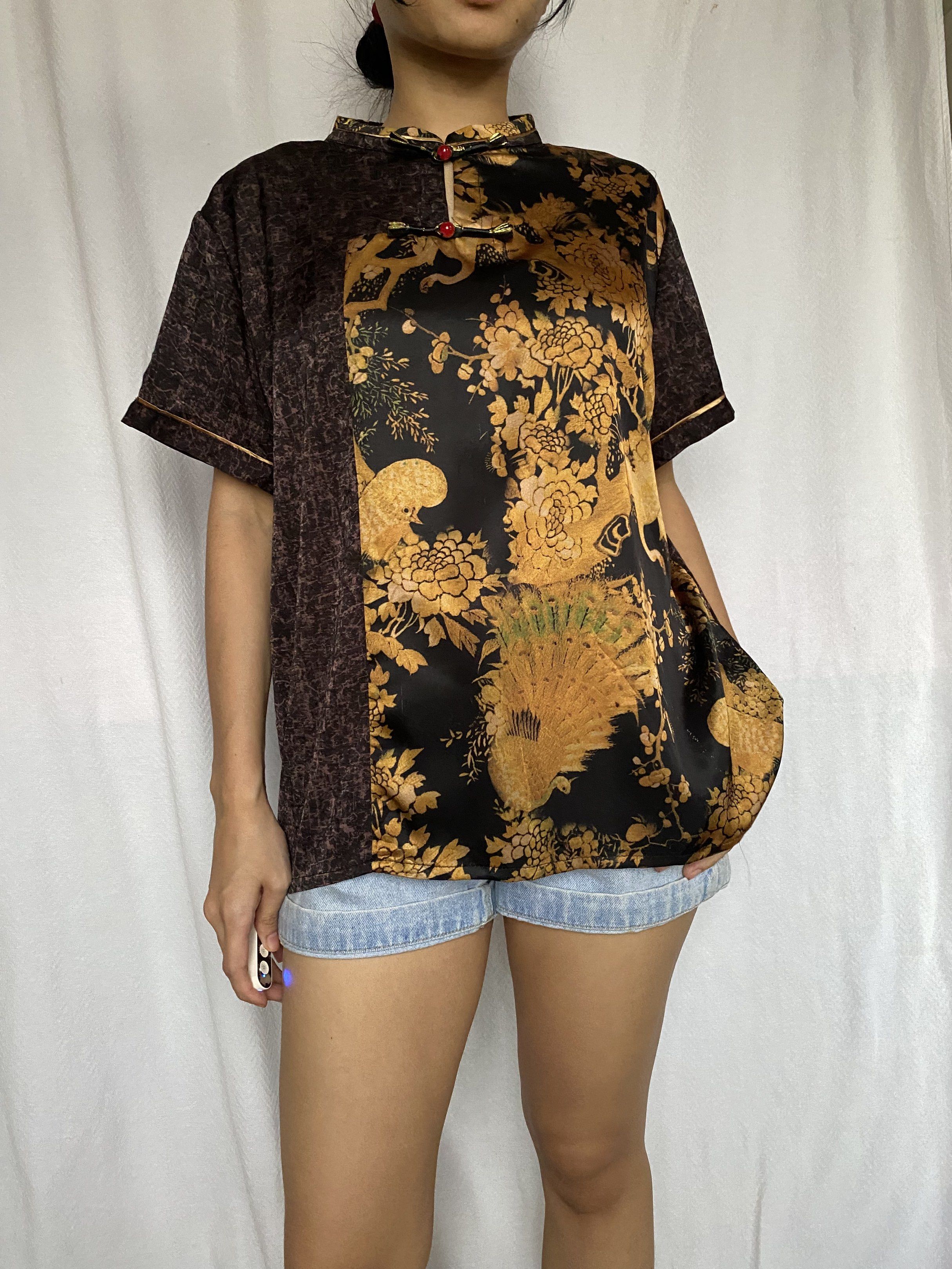 Vintage Chinese Style Top frog buttons (Category: Blouses) located in Tarlac. Submitted by himesells (Listing ID 1420241228, Image 1). Description: - Vintage top - Mandarin collar and short sleeves - Unique design: brown patterned fabric on one side, black fabric with gold floral and bird patterns on the other - Red button closures - Stylish and unique look.