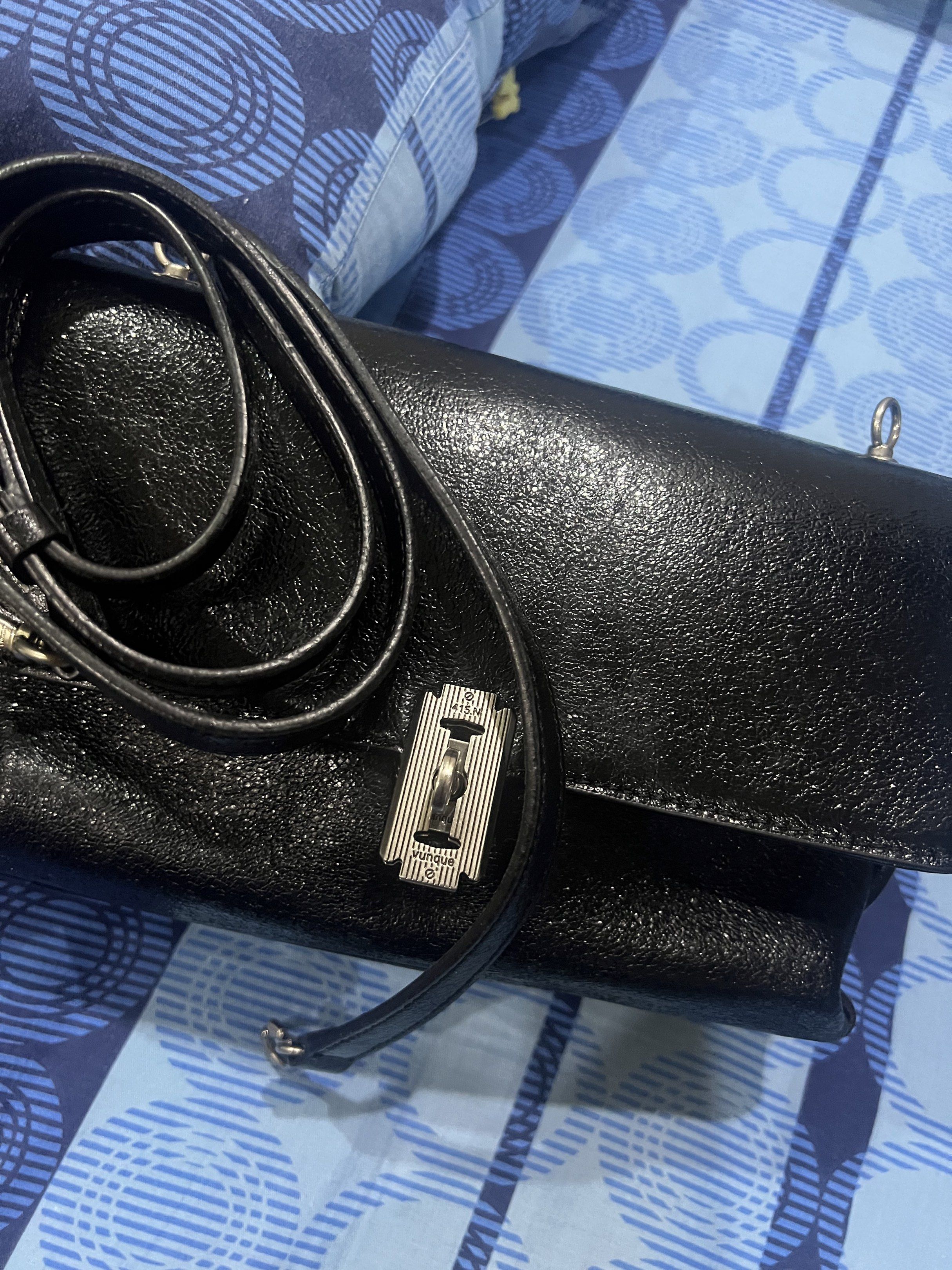 Vunque Baguette Bag - S (Category: Luxury Bags & Wallets) located in Dasmarinas. Submitted by stuffsbyklay (Listing ID 1420289421, Image 1). Description: Black Baguette shoulder bag from Vunque. Features a flap closure with a silver-tone clasp. Includes a detachable shoulder strap. The interior has a zippered pocket. 9.5/10. Very good condition .
