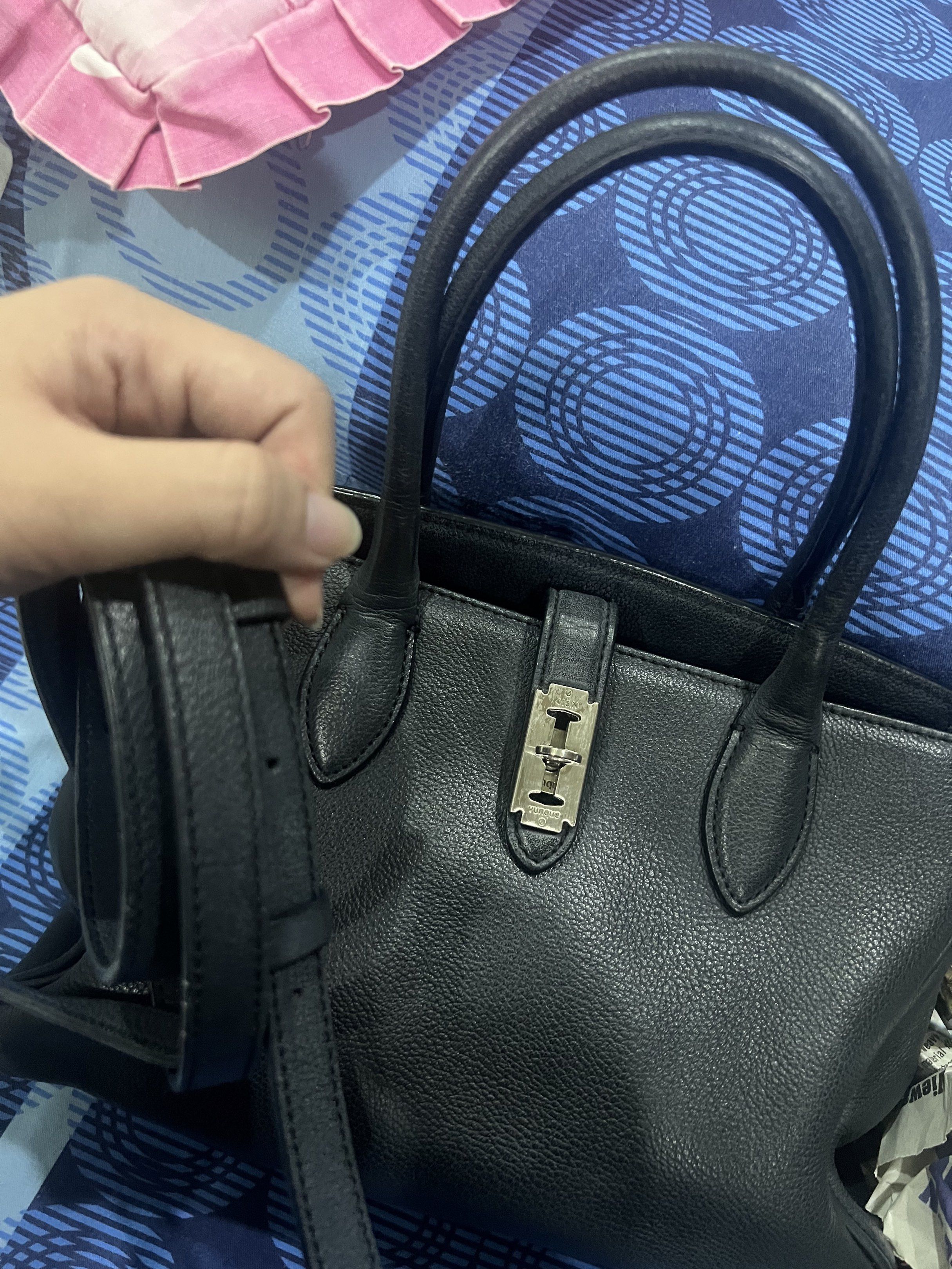 Vuque Toque Handbag with Shoulder Strap (Category: Luxury Bags & Wallets) located in Dasmarinas. Submitted by stuffsbyklay (Listing ID 1420290404, Image 2). Description: - Black Vuque handbag - Top handle and detachable shoulder strap - Silver-tone clasp closure - Fabric lining - Includes brand tag and product code - Made of textured leather - Classic, structured design .