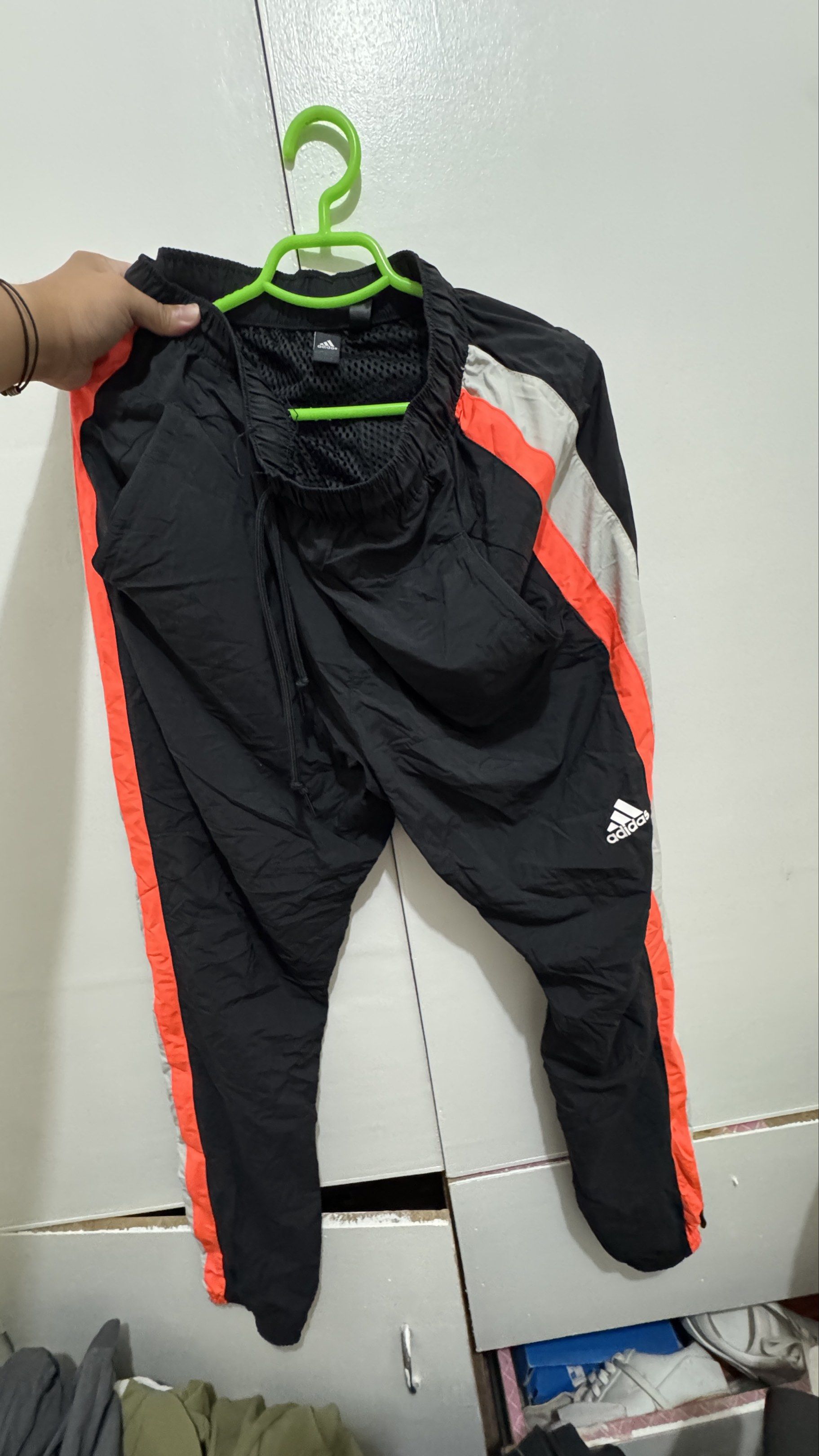 Adidas Track Pants - Black with Orange Stripes (Category: Joggers) located in Manila. Submitted by offthehype (Listing ID 1420442071, Image 1). Description: - Adidas track pants - Color: Black with orange and grey stripes - Size: L - Features Adidas logo - "THREE STRIPES" printed on side - Drawstring waist - Mesh lining - Material: 100% nylon (body), 100% polyester (lining) If set kukunin I can give it 1800 for the set.