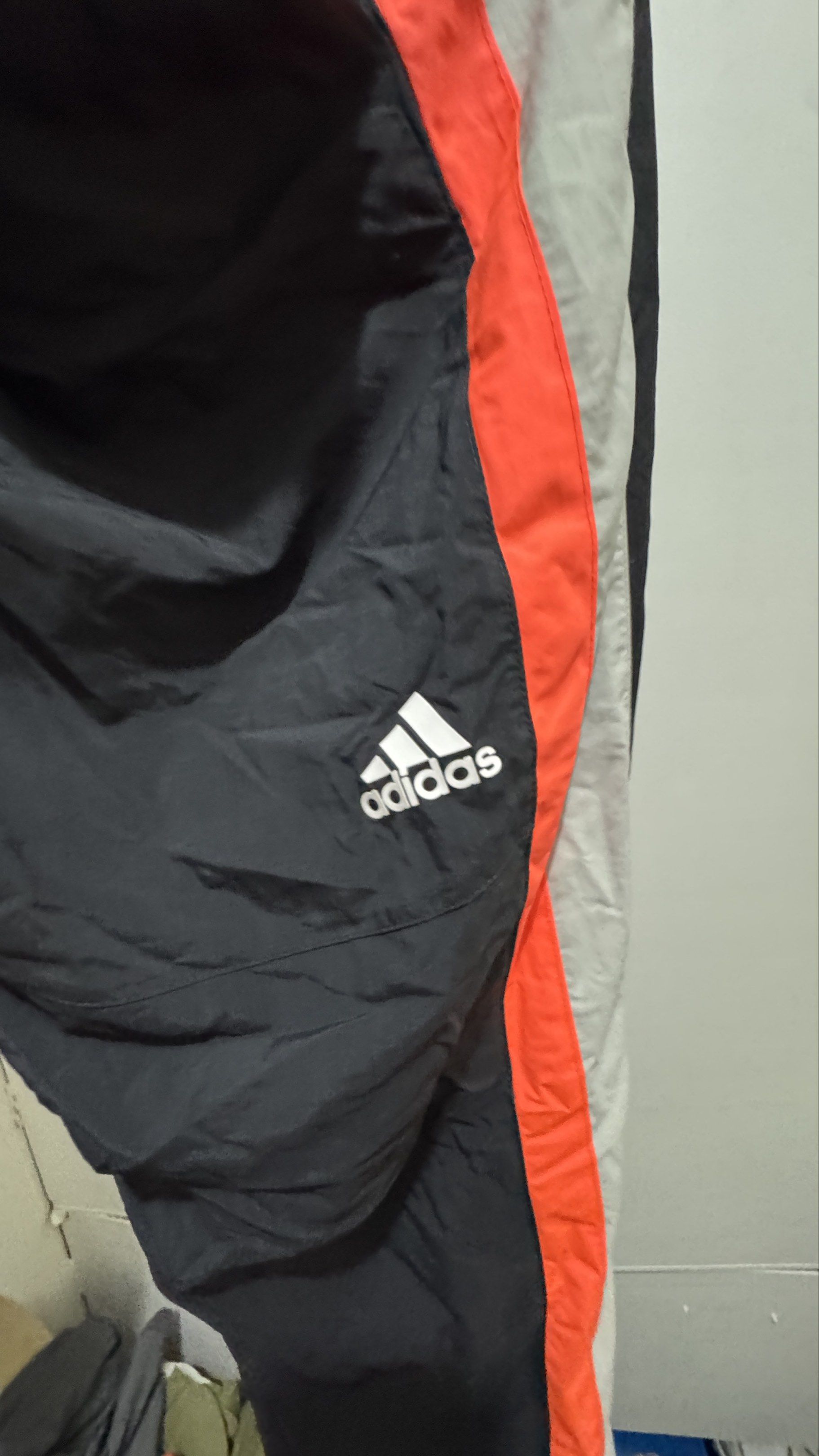 Adidas Track Pants - Black with Orange Stripes (Category: Joggers) located in Manila. Submitted by offthehype (Listing ID 1420442071, Image 2). Description: - Adidas track pants - Color: Black with orange and grey stripes - Size: L - Features Adidas logo - "THREE STRIPES" printed on side - Drawstring waist - Mesh lining - Material: 100% nylon (body), 100% polyester (lining) If set kukunin I can give it 1800 for the set.