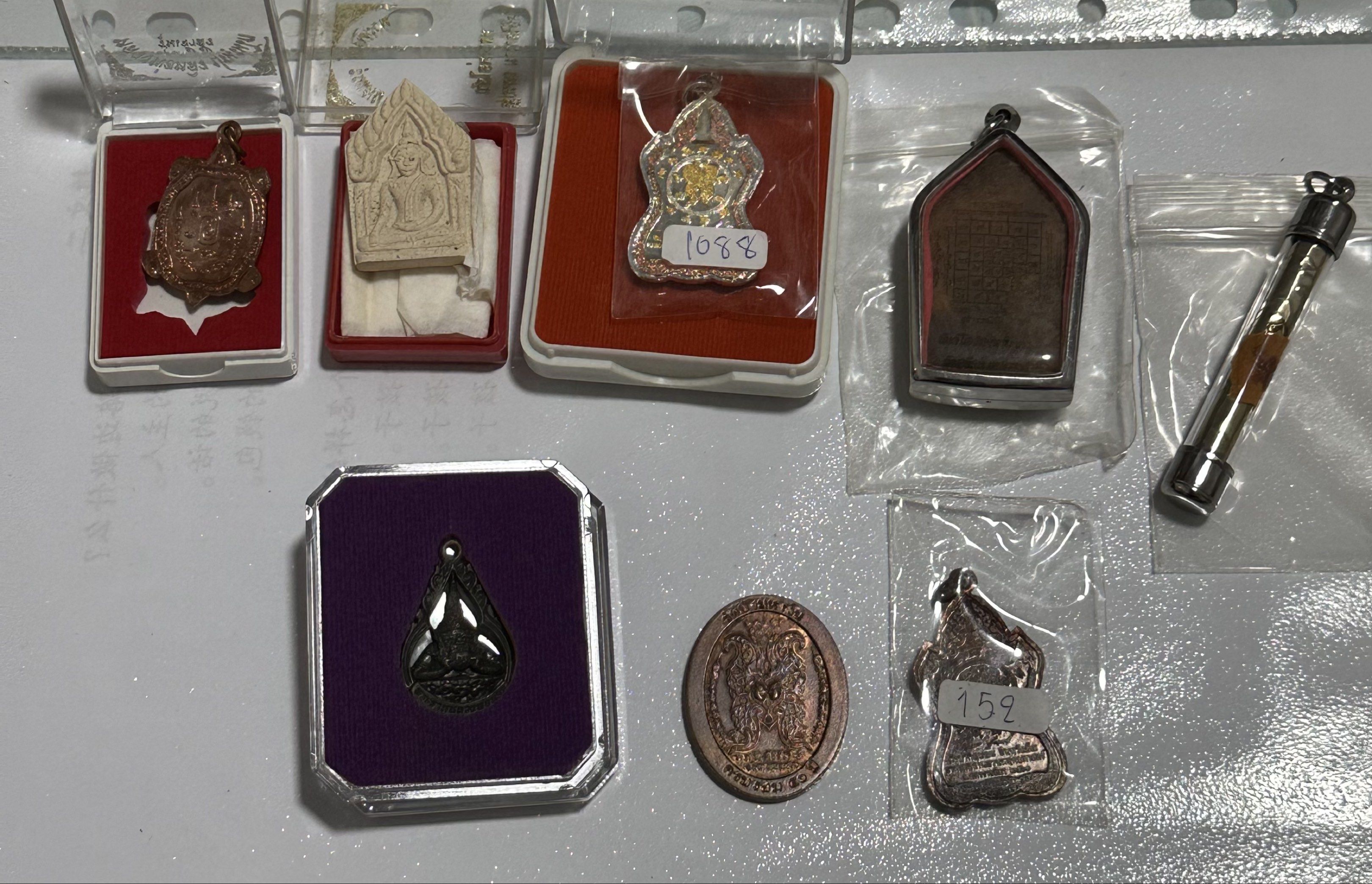 Amulets (Category: Religious Items) located in Singapore. Submitted by thetriftloom_owl (Listing ID 1420467821, Image 4). Description: - Assortment of amulets. - Diverse designs and shapes. - Various materials used. - Some amulets are encased. - Well-preserved condition. - total 50 plus amulets together with 1st listing..