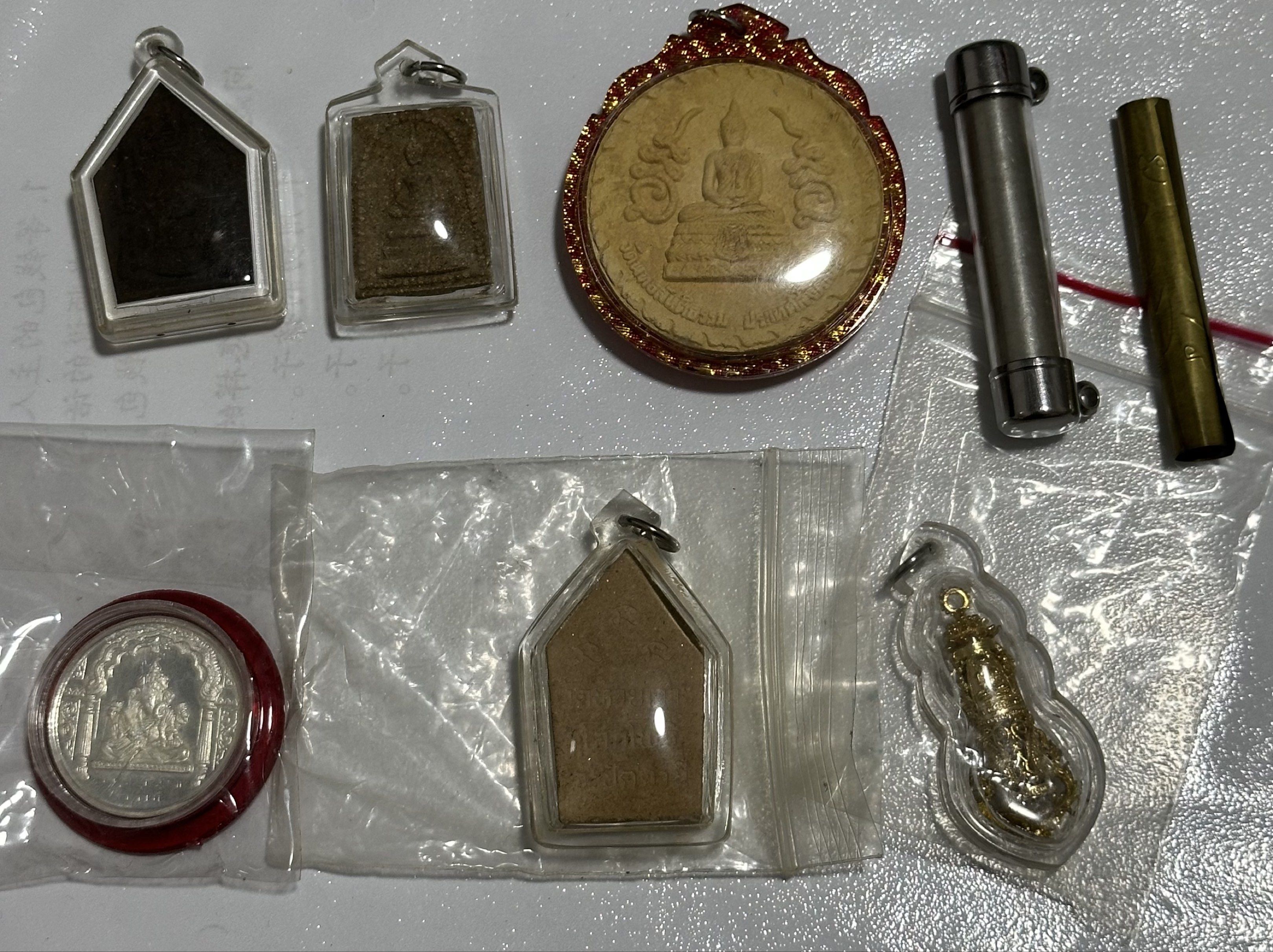 Amulets (Category: Religious Items) located in Singapore. Submitted by thetriftloom_owl (Listing ID 1420467821, Image 8). Description: - Assortment of amulets. - Diverse designs and shapes. - Various materials used. - Some amulets are encased. - Well-preserved condition. - total 50 plus amulets together with 1st listing..