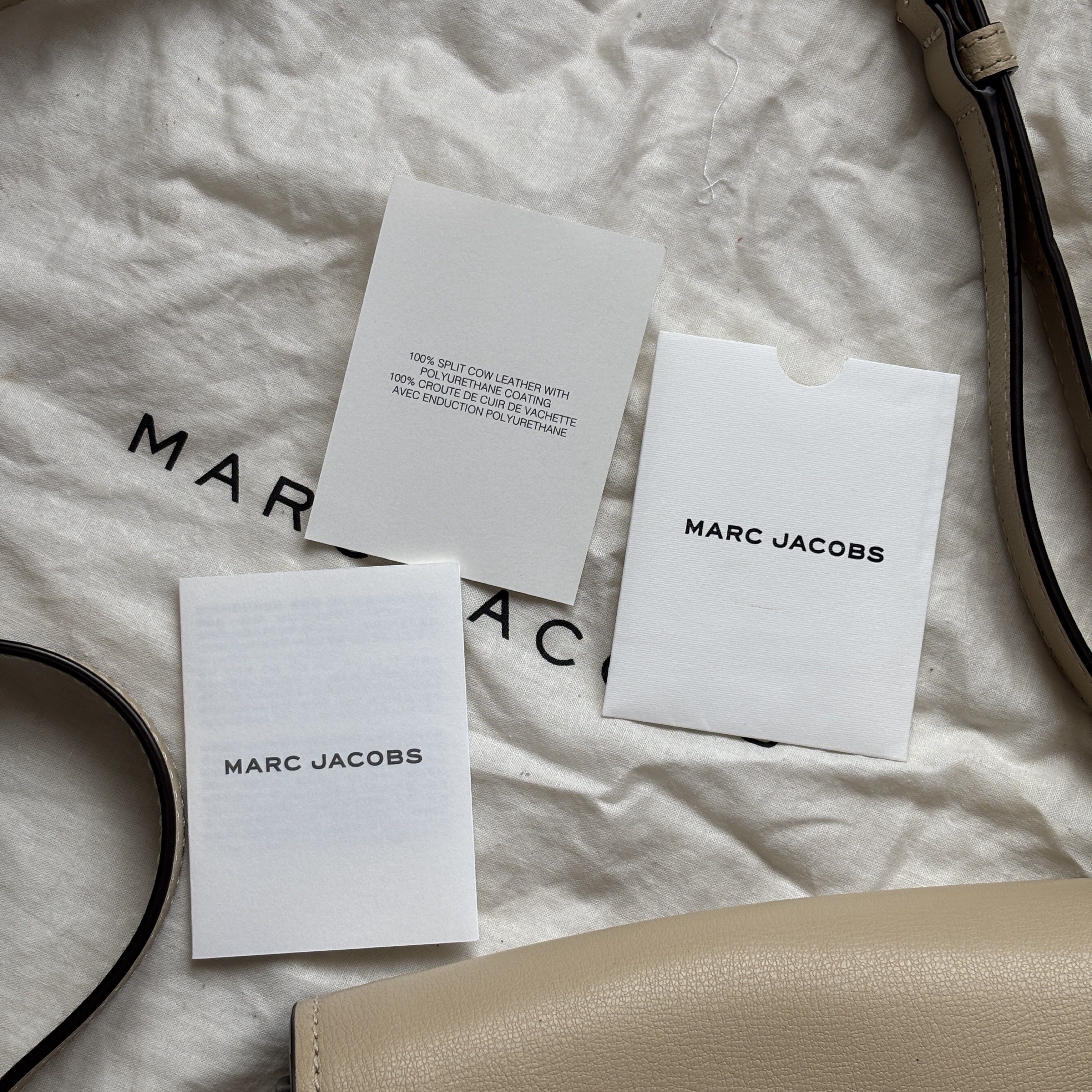 Authentic Marc Jacobs Mini Rider Crossbody Bag (Category: Luxury Bags & Wallets) located in Binan City. Submitted by rr.stuff (Listing ID 1420538917, Image 2). Description: FIXED PRICE - Authentic Marc Jacobs crossbody bag, bought in Japan - Light beige exterior - Flap closure - Gold-tone hardware - Interior pocket - Includes dust bag and original care booklet and card - some scratches and crusted leather on the gold tag - some black leather lini