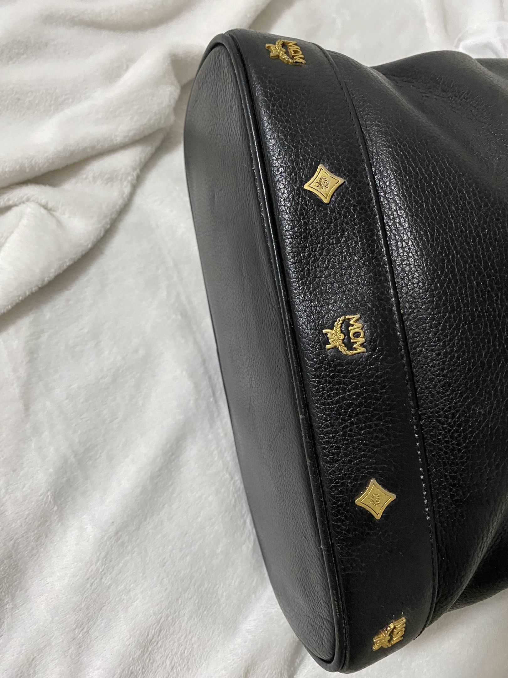 Authentic MCM Black Leather Tote Bag (Category: Luxury Bags & Wallets) located in Santa Rosa. Submitted by sassycollection. (Listing ID 1420358610, Image 3). Description: - MCM black leather tote bag - Top handle design with flap closure - Gold-tone hardware with MCM logo - Interior zip pocket - MCM logo lining - Spacious interior.