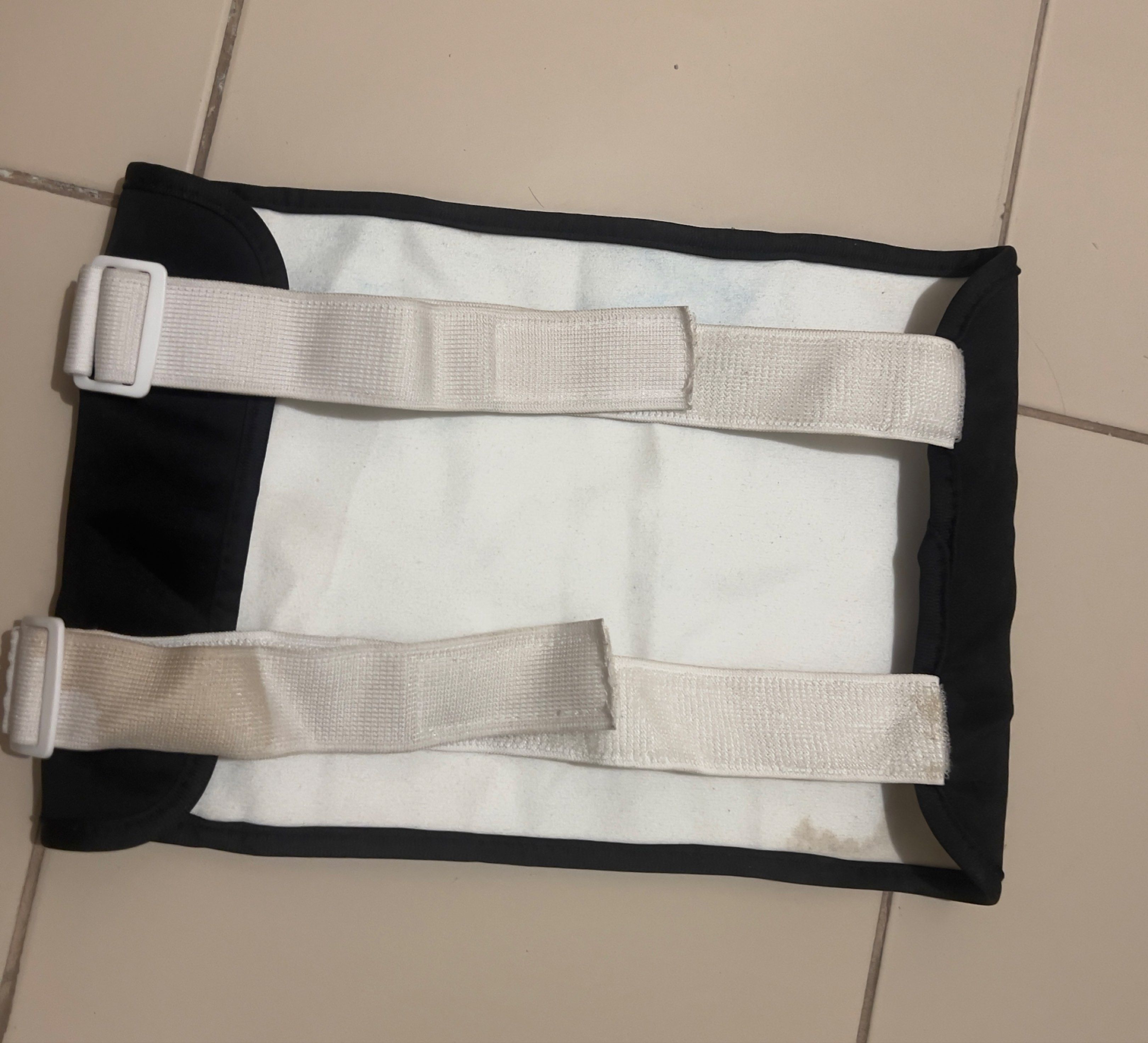 Black waist wrap for hot packs (Category: Body Care) located in Cainta. Submitted by barbie714 (Listing ID 1420518732, Image 2). Description: - Features a zippered pocket - Includes two adjustable straps - Rectangular shape - Black exterior with white interior lining.