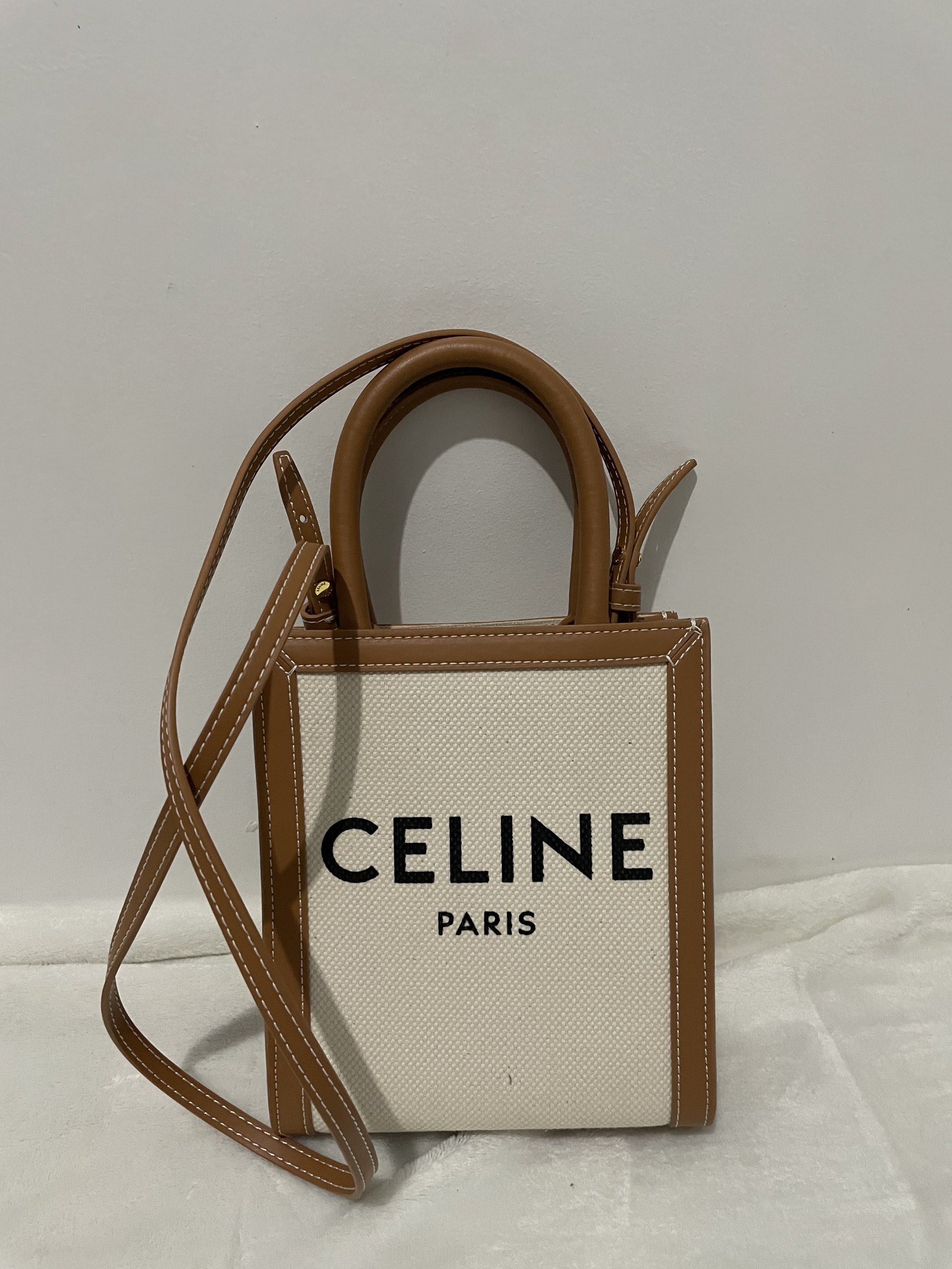 Celine Mini Vertical Cabas Bag (Category: Luxury Bags & Wallets) located in Manila. Submitted by reloom (Listing ID 1420406128, Image 1). Description: - Celine Mini Vertical Cabas Bag—Japan bought on preloved stores - Canvas and calfskin material - Tan leather trim and handles - Detachable shoulder strap - Celine logo on front - Rectangular shape - Light canvas interior.