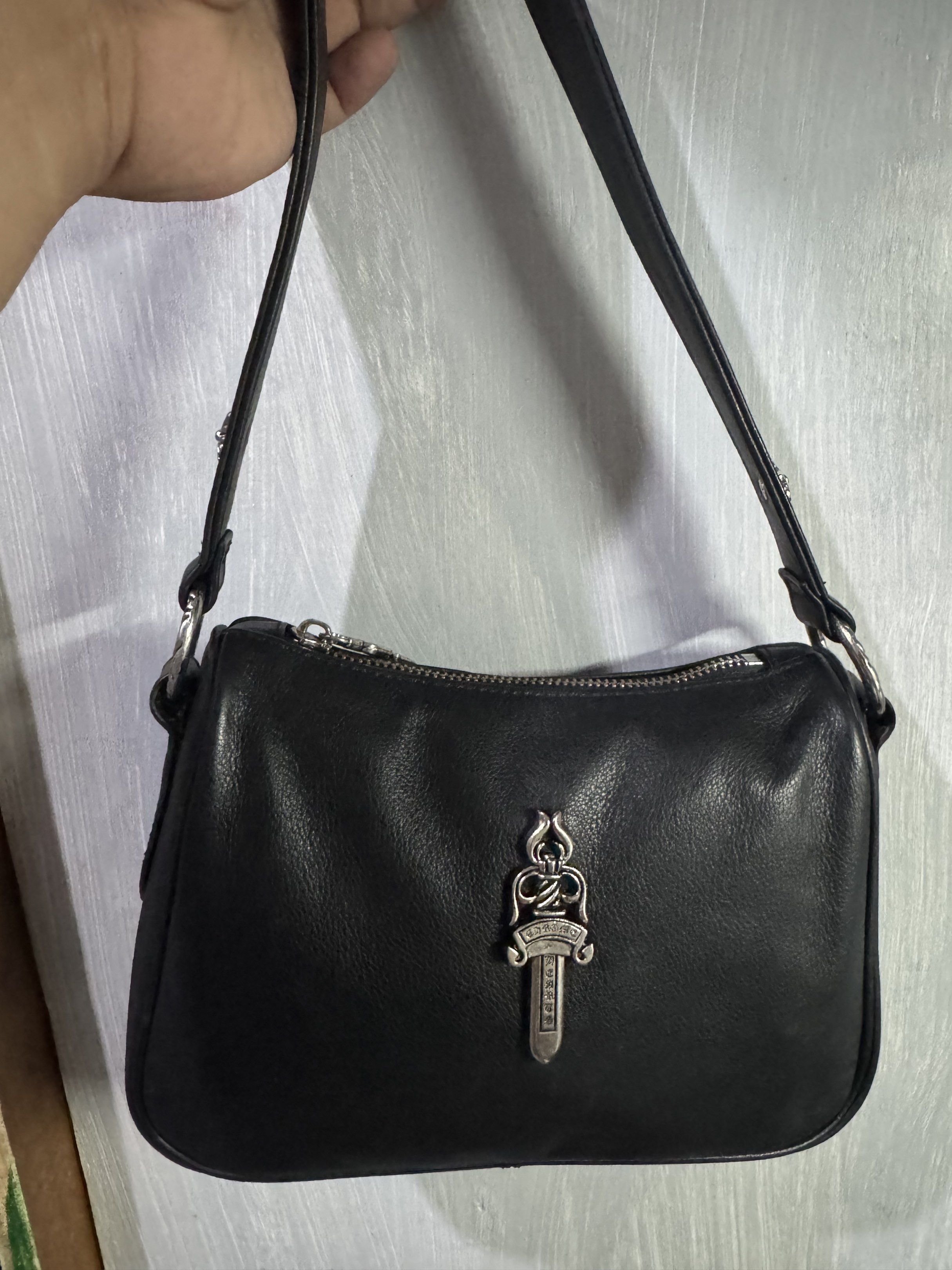 Chrome Hearts Black Leather Shoulder Bag (Category: Luxury Bags & Wallets) located in Manila. Submitted by dane18 (Listing ID 1420429949, Image 1). Description: - Black leather shoulder bag - Silver hardware - Chrome Hearts cross details - Dagger zipper pull - Top zipper closure - Shoulder strap - Lined interior - Chrome Hearts silver ring.