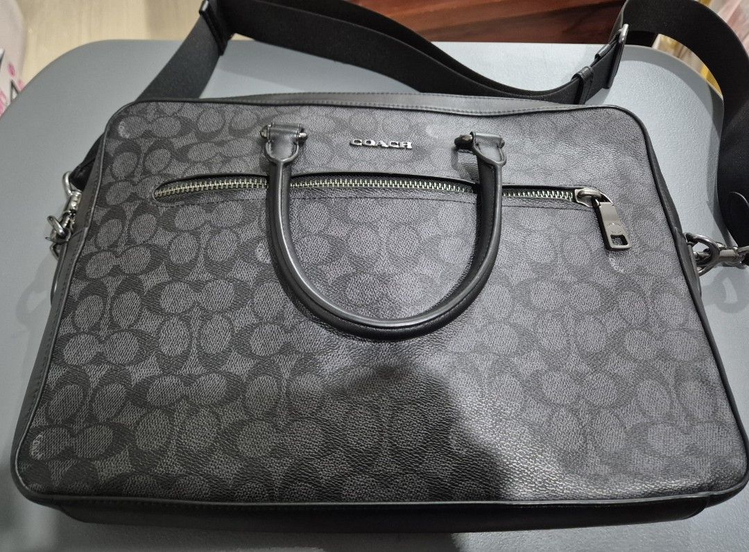 Coach slim briefcase/ laptop bag (Category: Luxury Bags & Wallets) located in Cabuyao City. Submitted by AR700 (Listing ID 1417924184, Image 3). Description: - Coach laptop bag - Signature pattern - Top handle and detachable shoulder strap - Front zipper pocket - Main compartment - Black exterior - Silver-tone hardware - Carries laptop and essentials measurement horizontal 14.5 inches Bought 20k Used once then stored comes with zalora luxury box 