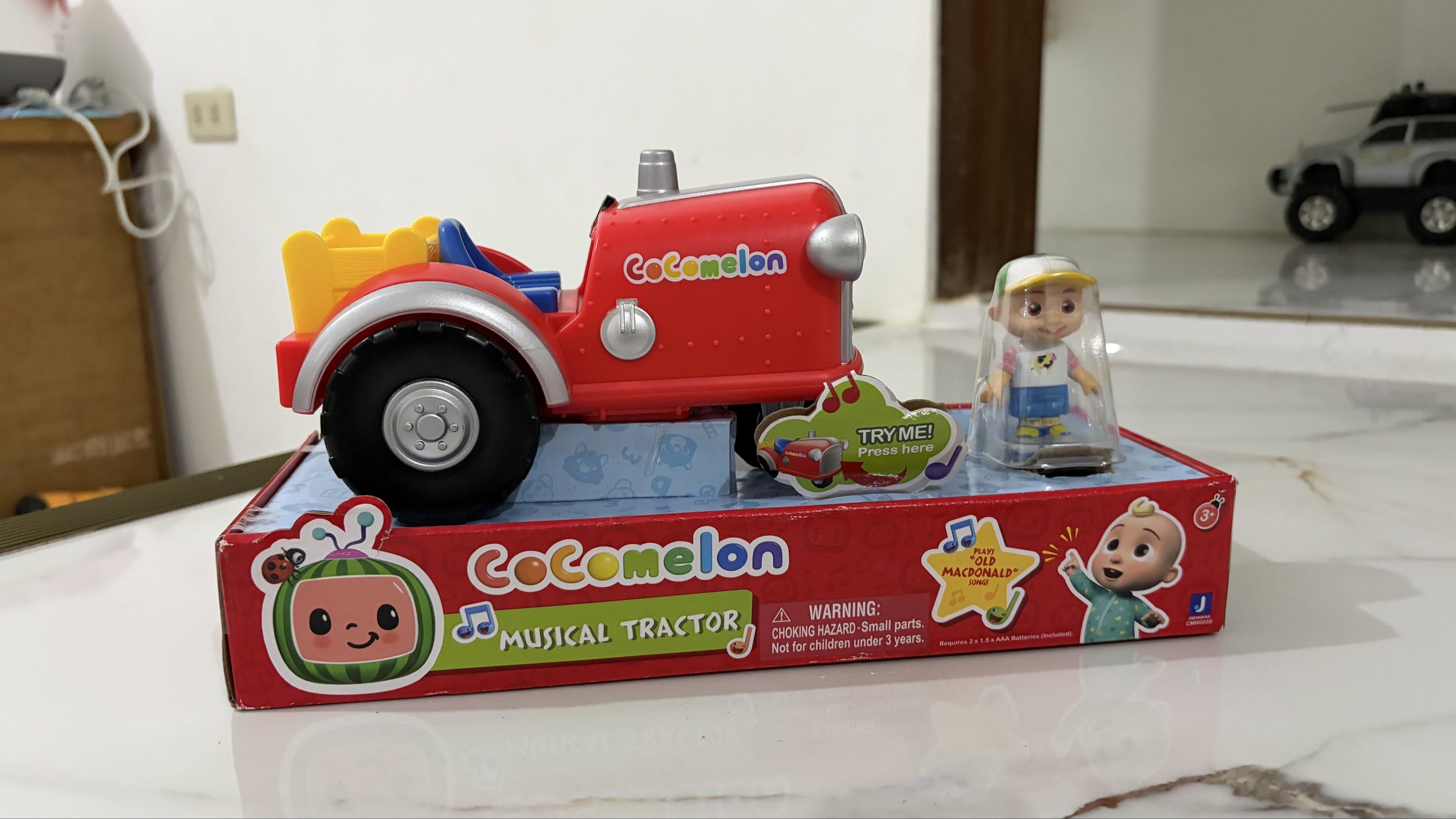 CoComelon Musical Tractor Toy (Category: Kids Toys) located in Bulacan. Submitted by speczone (Listing ID 1420497446, Image 1). Description: - CoComelon Musical Tractor toy included. - Comes with a figure. - Tractor color: Red with black wheels and yellow bed. - Features the 'Try Me! Press here' button. - Box features the CoComelon logo and 'Musical Tractor' text. - from US box (padala from a relative).