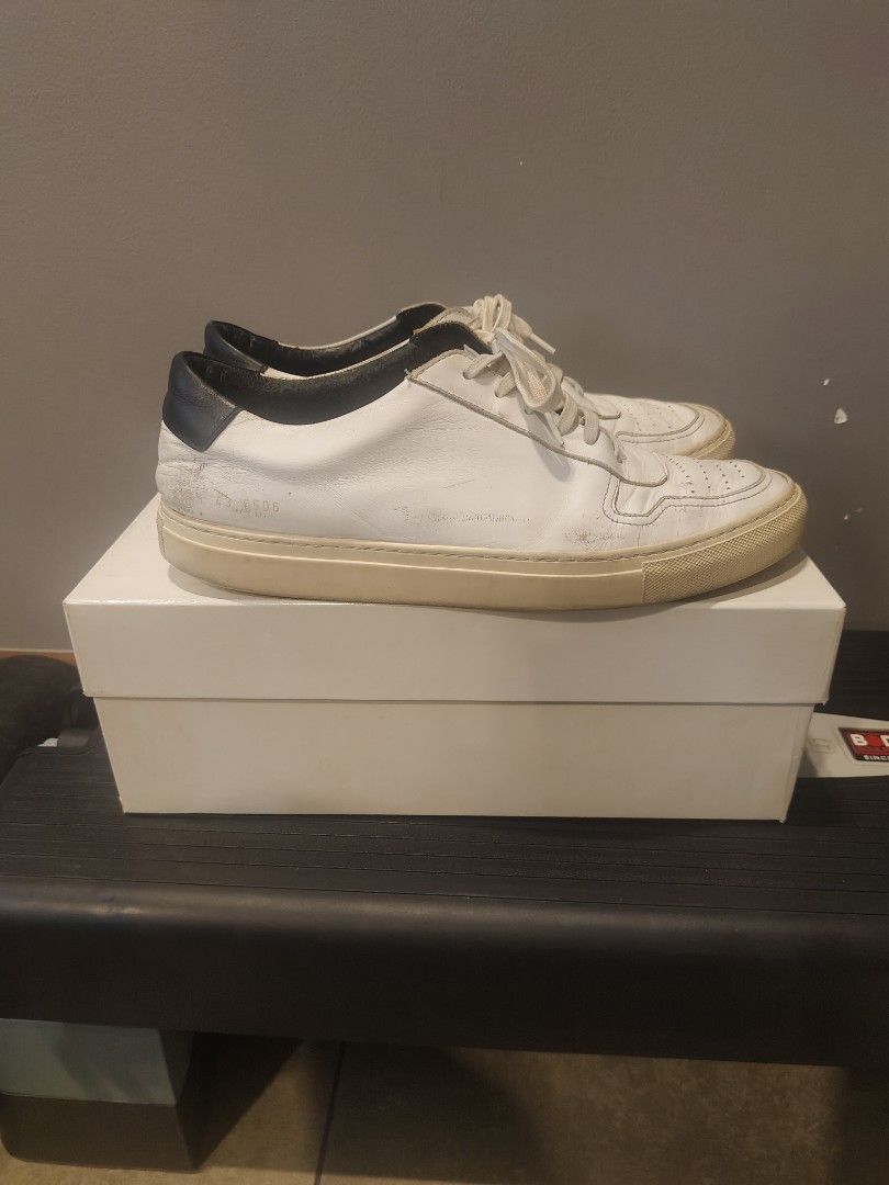 Common Projects Achilles Low Sneakers (Category: Sneakers) located in Muntinlupa City. Submitted by cezzy82 (Listing ID 1420467124, Image 2). Description: - Common Projects Achilles Low sneakers - Color: White with black heel tab - Size: 43 - Includes original box - Signs of wear present.