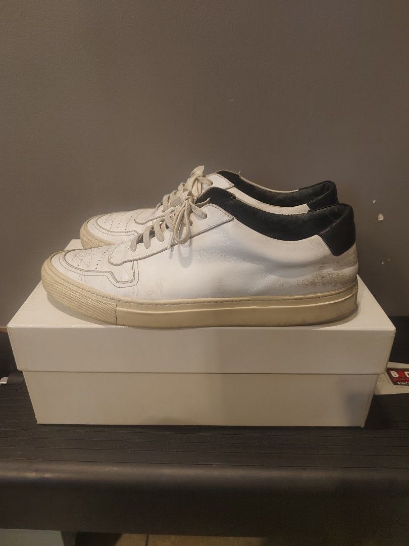 Common Projects Achilles Low Sneakers (Category: Sneakers) located in Muntinlupa City. Submitted by cezzy82 (Listing ID 1420467124, Image 1). Description: - Common Projects Achilles Low sneakers - Color: White with black heel tab - Size: 43 - Includes original box - Signs of wear present.