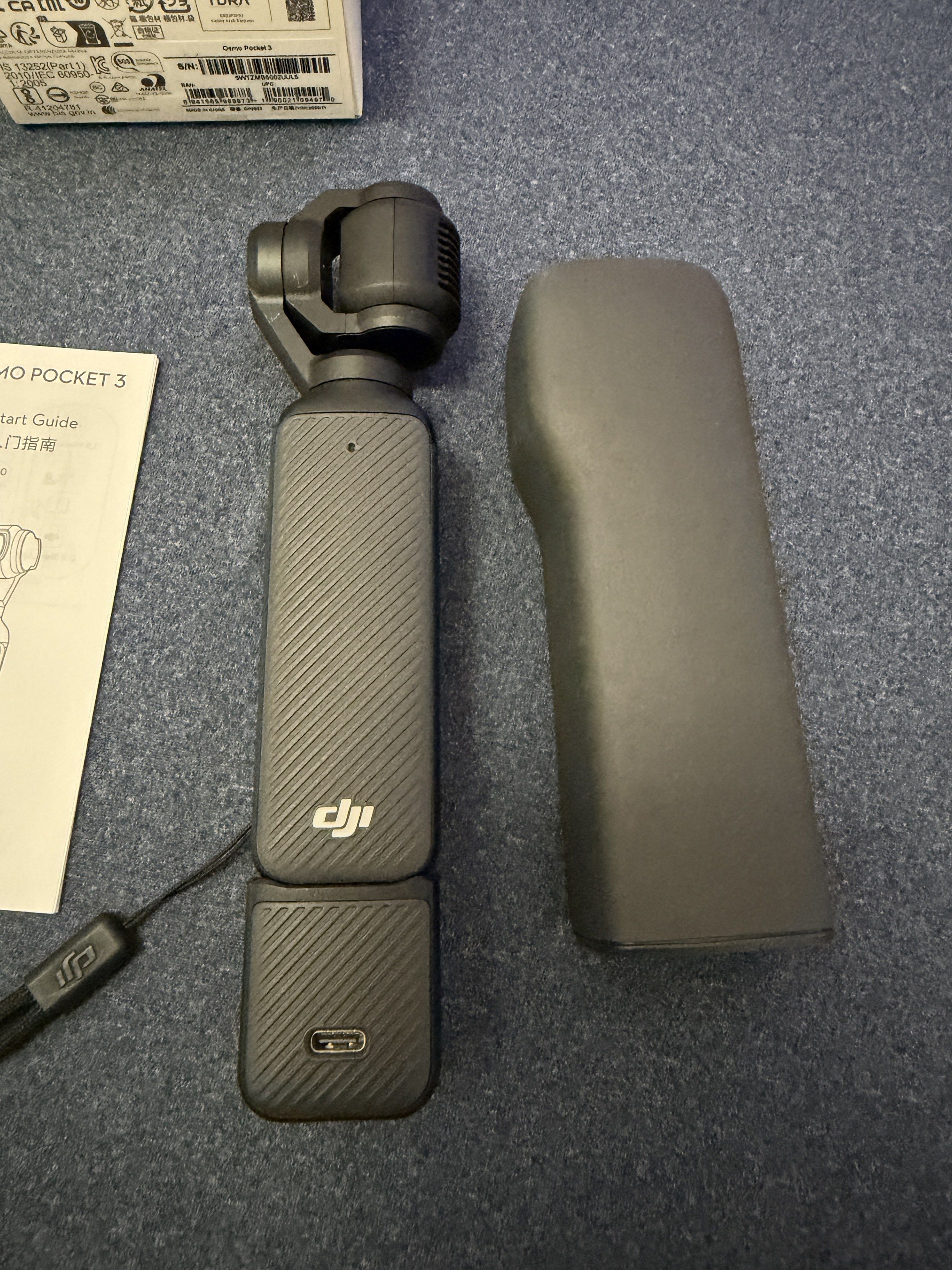 DJI Osmo Pocket 3 (Category: Cameras) located in Rizal. Submitted by bubblesnow (Listing ID 1420477931, Image 3). Description: DJI Osmo Pocket 3 camera. Includes the camera, box, charging cable, and documentation. Also comes with a protective cover. The camera has a built-in screen and a wrist strap. The box shows the model name and other details. Bought 2024, used three times only. SD card not included .