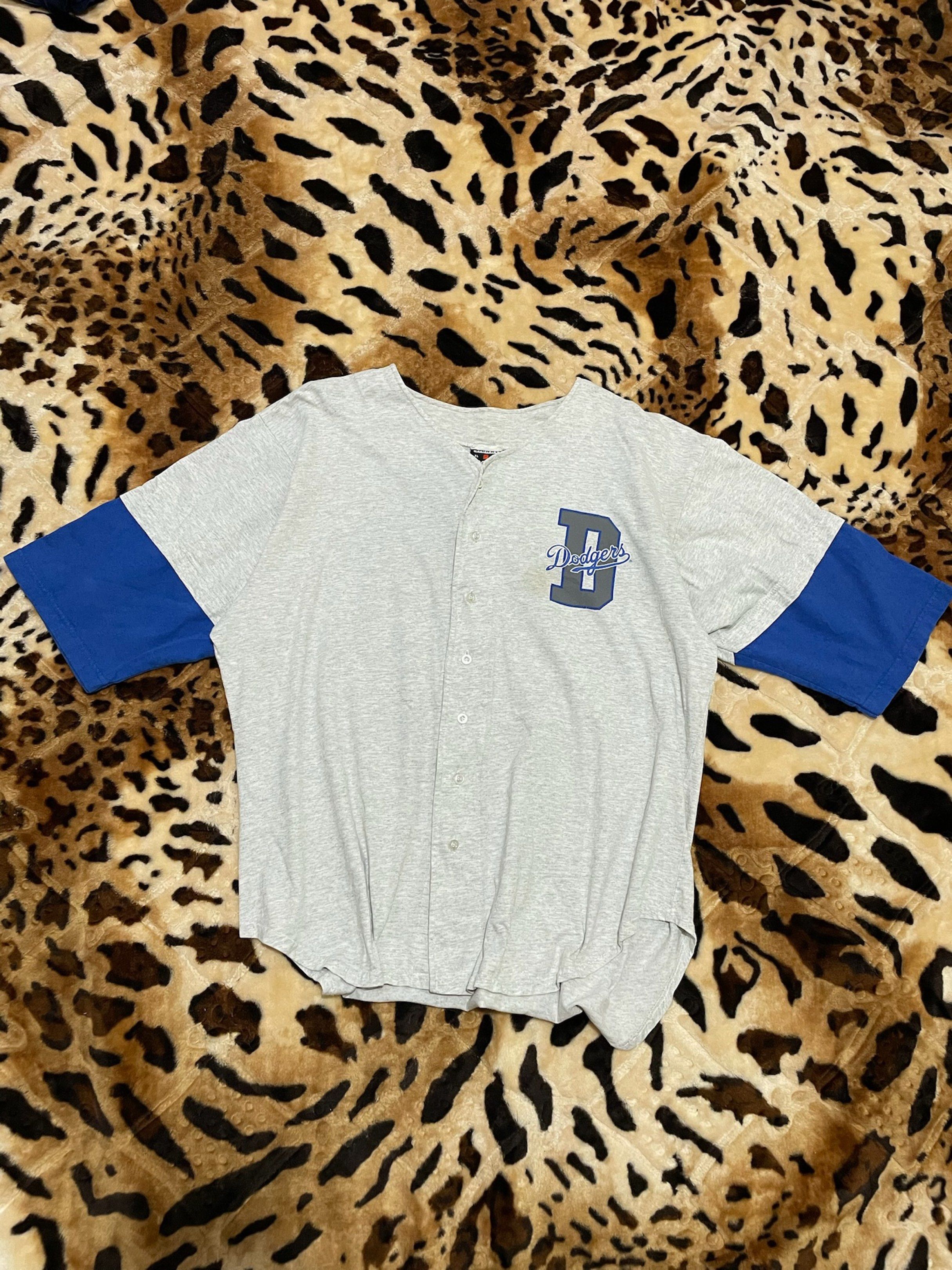 Dodgers Baseball Jersey XL (Category: Tshirts & Polo Shirts ) located in Cabuyao City. Submitted by kisyana (Listing ID 1420525339, Image 1). Description: - Vintage Dodgers baseball jersey - Grey body with blue sleeves - Features the Dodgers logo - Size: XL - Material: 100% cotton - Made in the USA - Stadium Gear exclusive.