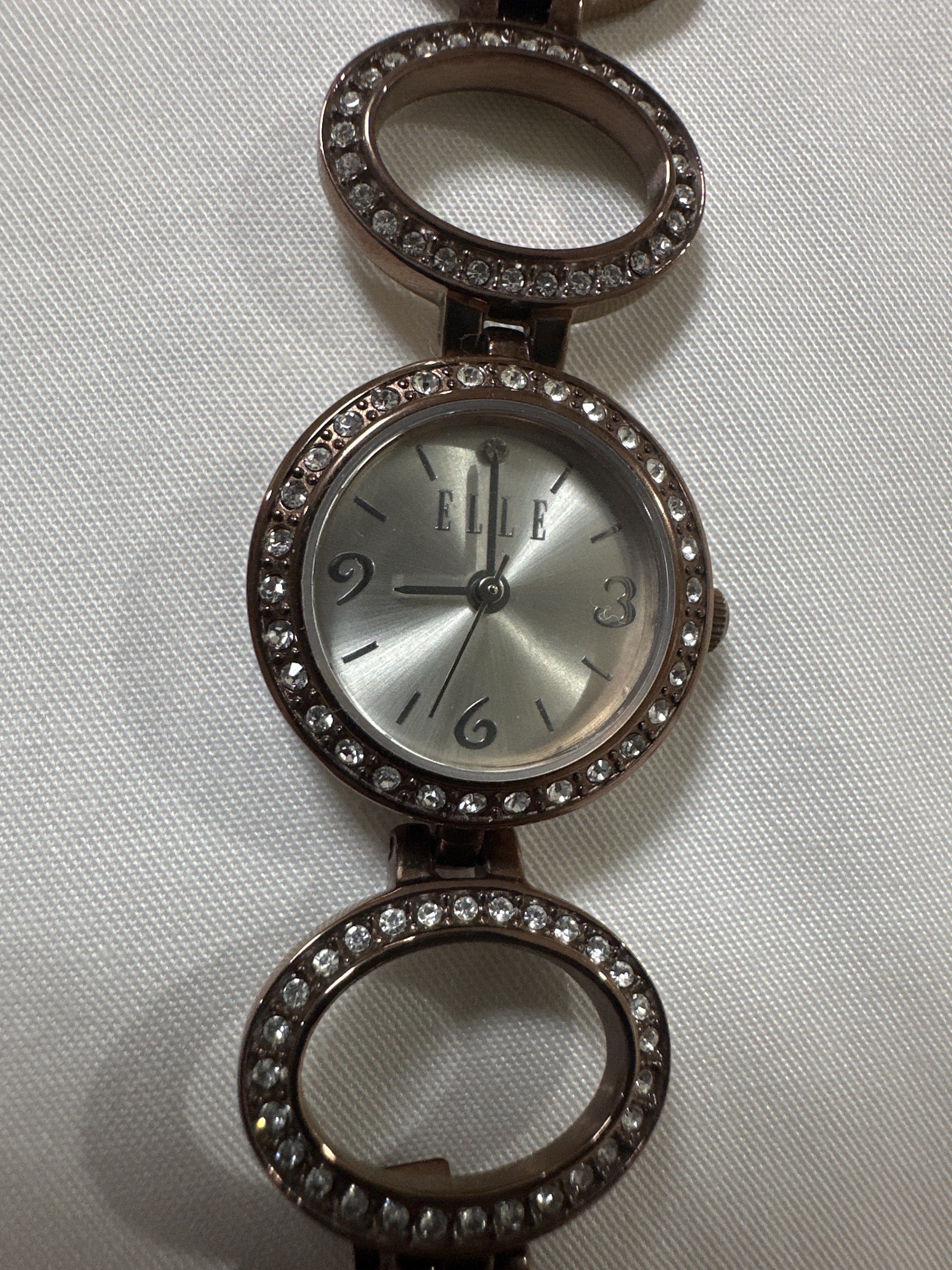 Elle Time Collection Ladies Watch (Category: Women's Watches) located in Quezon City. Submitted by sofia0228 (Listing ID 1420495492, Image 2). Description: - Elle Time Collection ladies watch - Silver dial with crystal accents - Brown metal bracelet - Elle logo on the back - Includes original tag.