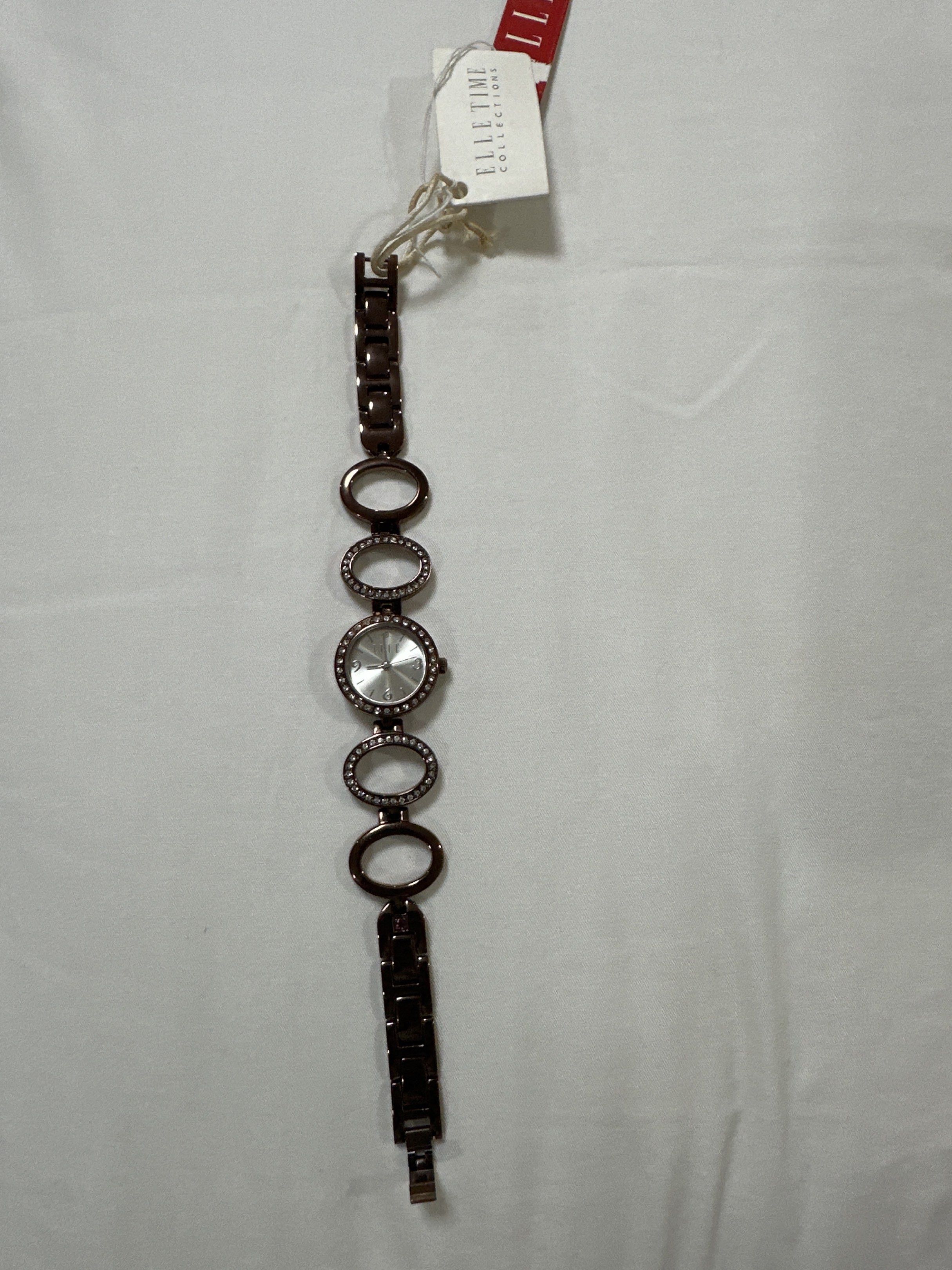 Elle Time Collection Ladies Watch (Category: Women's Watches) located in Quezon City. Submitted by sofia0228 (Listing ID 1420495492, Image 1). Description: - Elle Time Collection ladies watch - Silver dial with crystal accents - Brown metal bracelet - Elle logo on the back - Includes original tag.