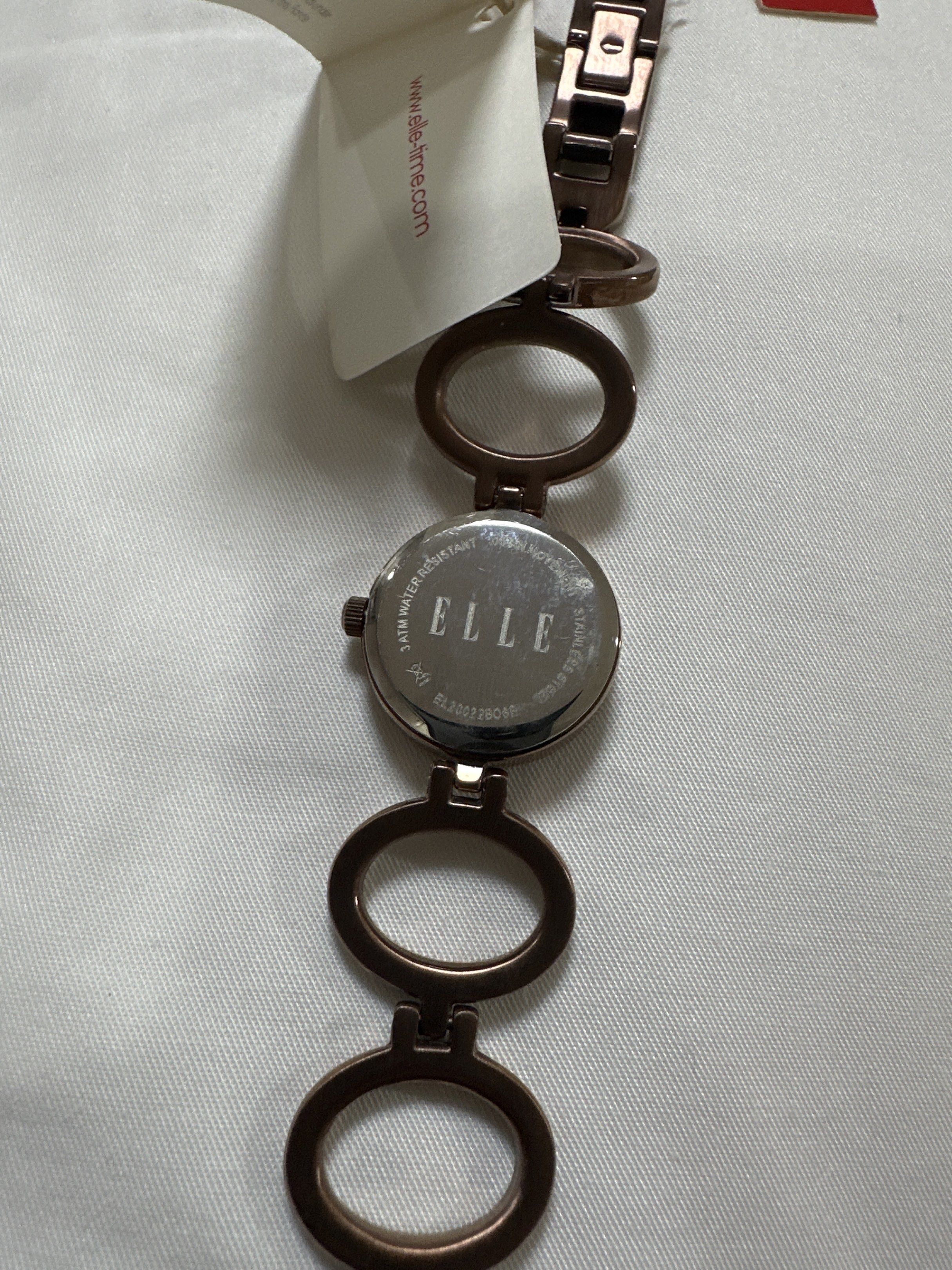 Elle Time Collection Ladies Watch (Category: Women's Watches) located in Quezon City. Submitted by sofia0228 (Listing ID 1420495492, Image 3). Description: - Elle Time Collection ladies watch - Silver dial with crystal accents - Brown metal bracelet - Elle logo on the back - Includes original tag.