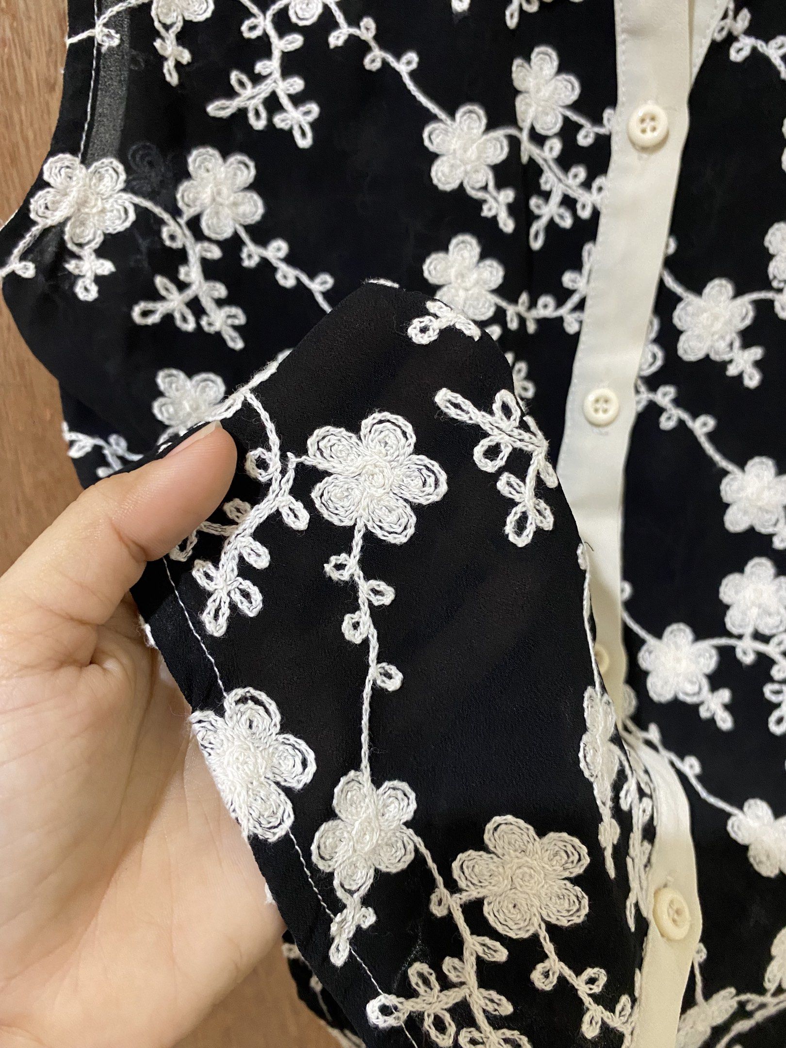 Embroidered Sleeveless Top with Peter Pan Collar (Category: Blouses) located in Guimba. Submitted by xeeeyaaaah (Listing ID 1420475275, Image 2). Description: - Sleeveless black top - Delicate floral embroidery - White Peter Pan collar - Button-down front - Lightweight material - Curved hemline - Feminine design.