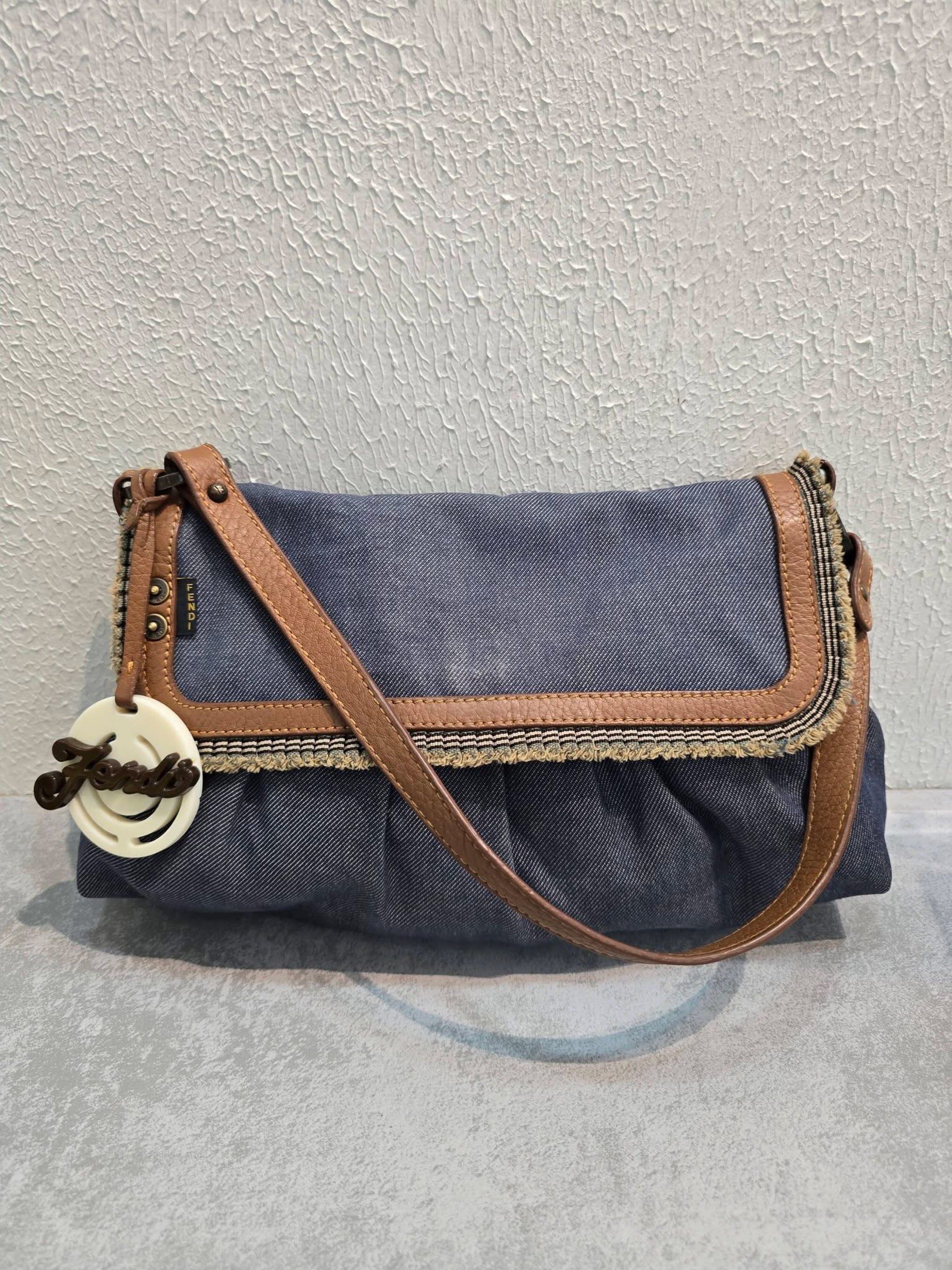 Fendi Denim Shoulder Bag (Category: Luxury Bags & Wallets) located in General Santos City (Dadiangas). Submitted by braverabbit.67 (Listing ID 1420442045, Image 2). Description: - Authentic Fendi shoulder bag - Denim exterior with brown leather strap and trim - Fabric-lined interior with small pocket - Features Fendi logo charm - Magnetic closure - Made in Italy.