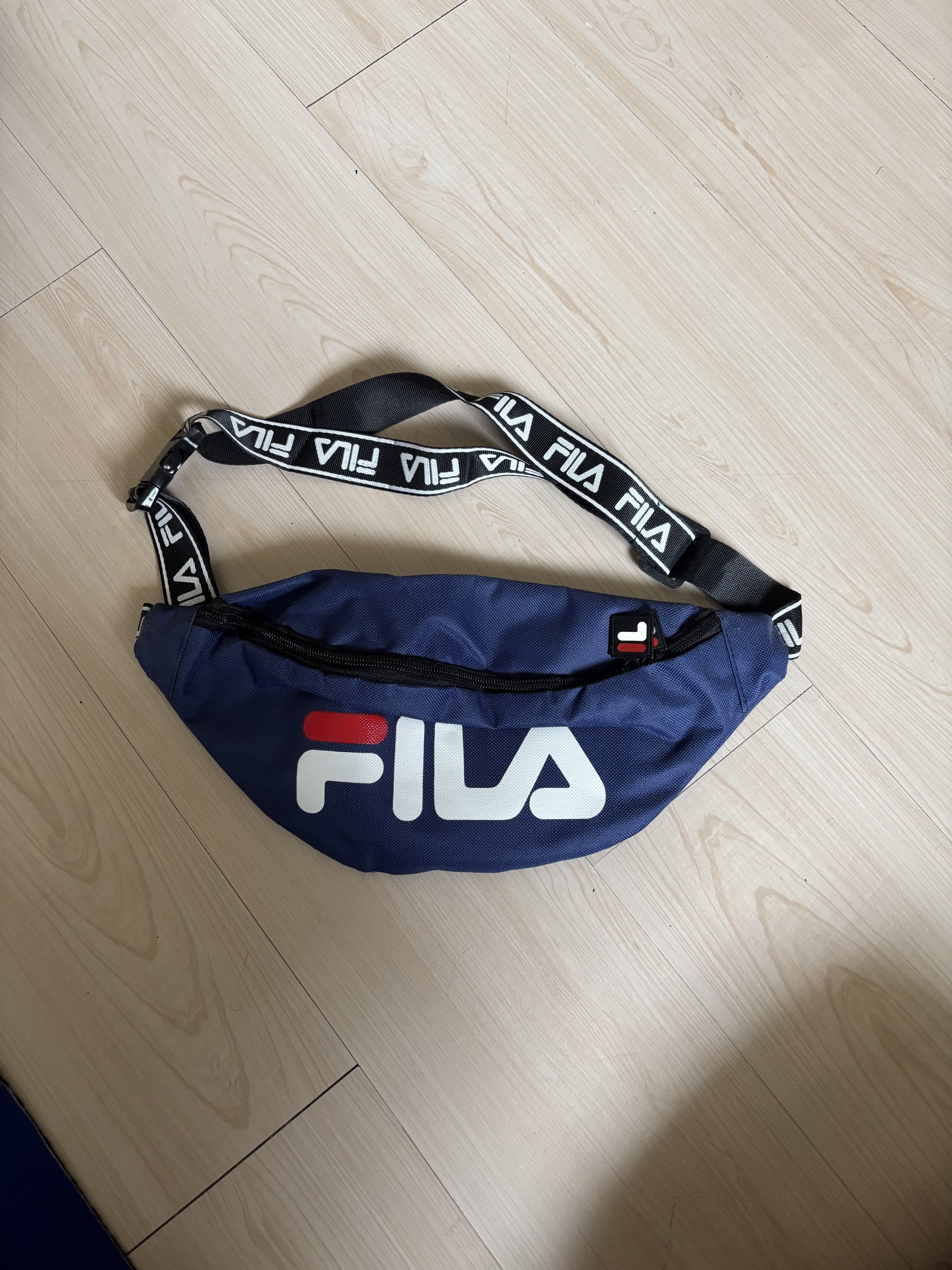 Fila Waist Bag - Navy Blue (Category: Belt bags, Clutches and Pouches) located in San Juan City. Submitted by chobei (Listing ID 1420414716, Image 2). Description: - Navy blue Fila waist bag - Black strap with Fila logo - Main compartment and internal pocket - Adjustable strap with buckle closure - Fila logo on front payment: gcash delivery: lalamove or meetup (buyer shoulders delivery fee) loc: san juan city dm for more details.