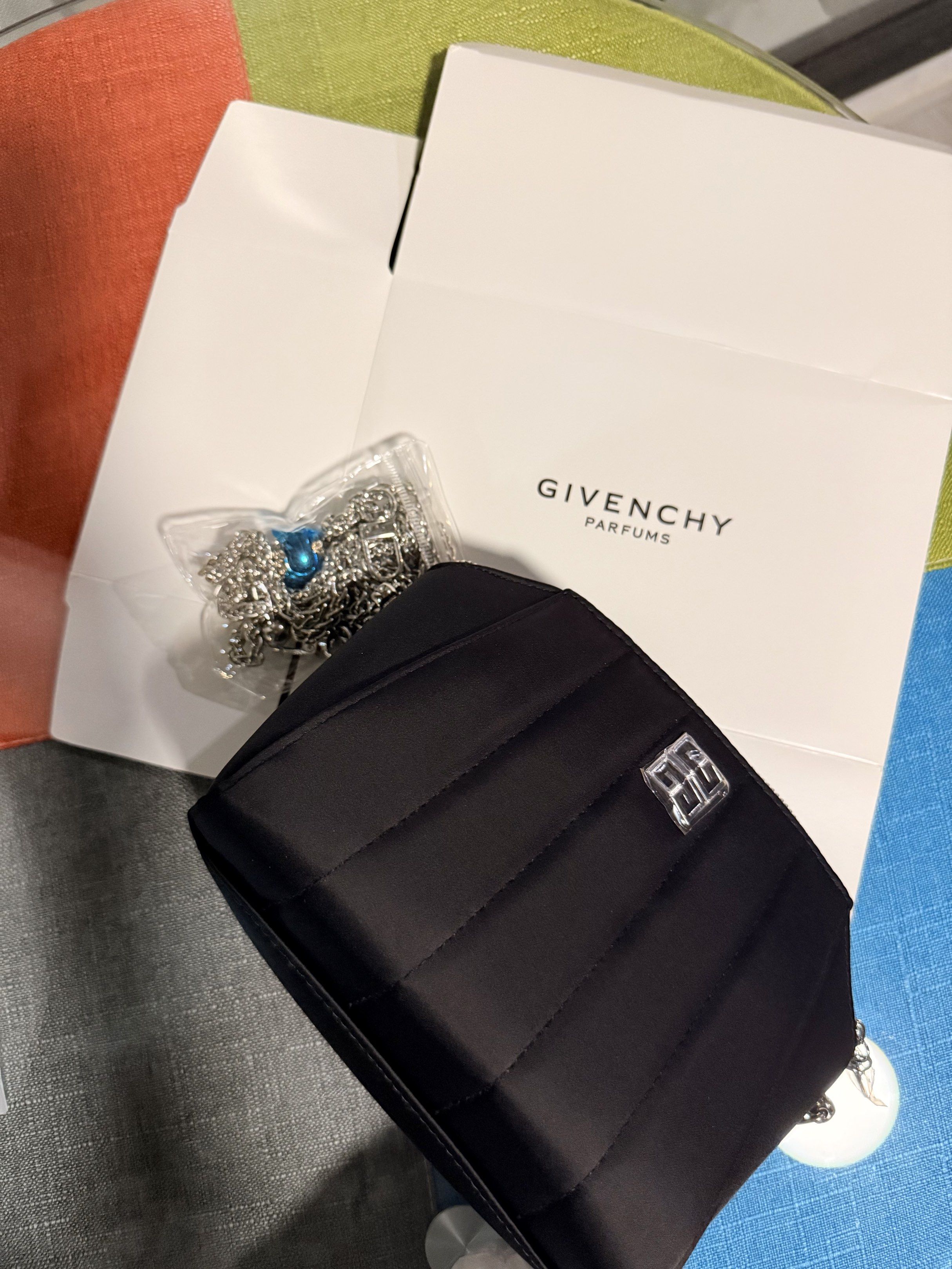 Givenchy Black Satin Clutch (Category: Luxury Bags & Wallets) located in Mabalacat. Submitted by dreamsolutions.326 (Listing ID 1420375204, Image 3). Description: - Givenchy black satin clutch - Quilted design - Silver-tone logo - Detachable chain strap - Comes with original box - Compact size - Ideal for evening events.