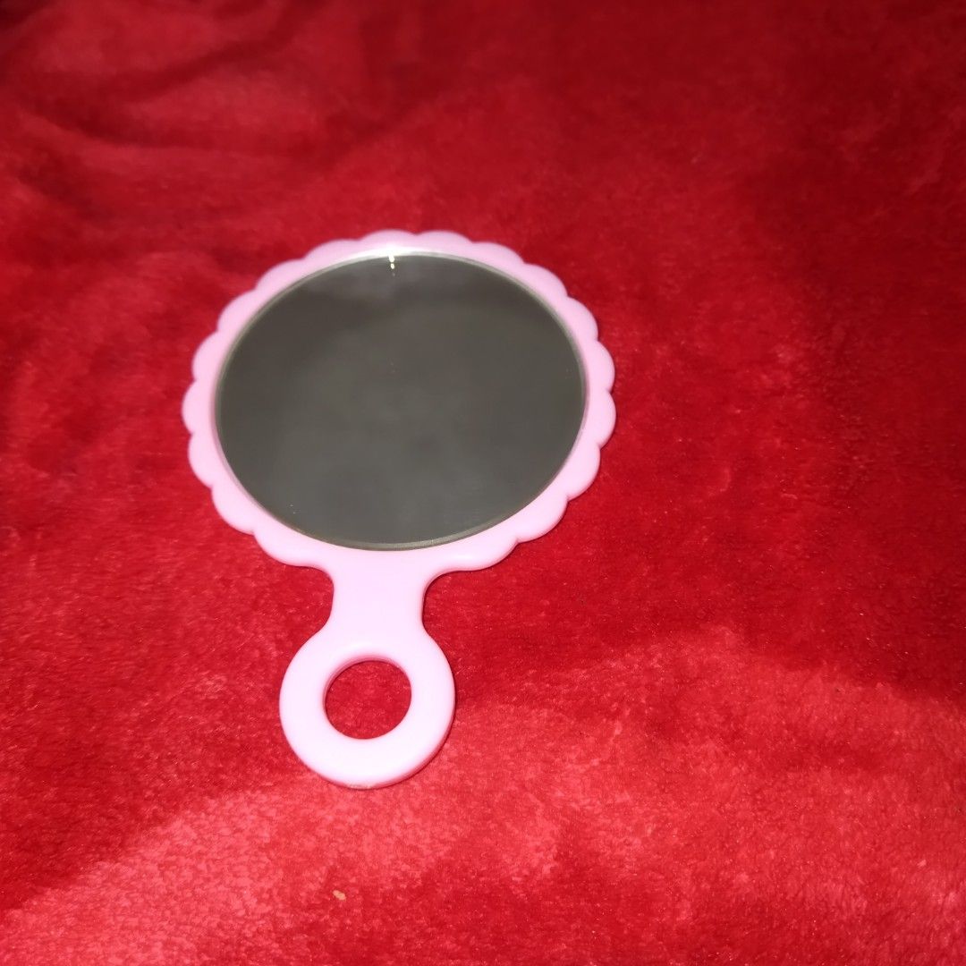 Hello Kitty Hand Mirror (Category: Mirrors) located in Santa Cruz. Submitted by madonnaching (Listing ID 1420533193, Image 2). Description: - Kitty design hand mirror - Pink scalloped frame - Clear reflection - Features Kitty's face and bow - Includes a handle with a ring - Cute and functional accessory.