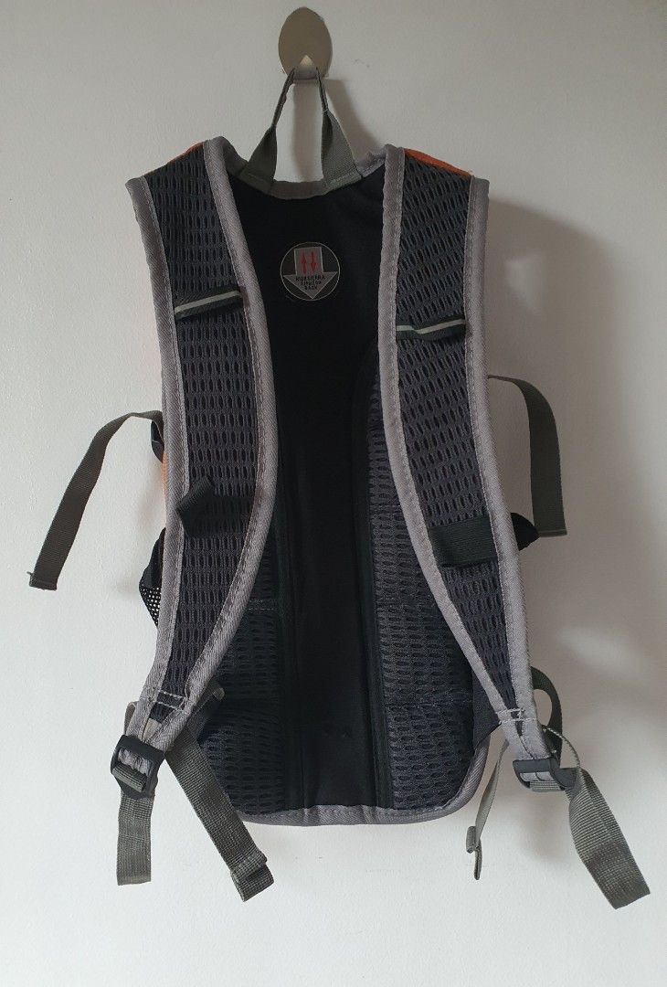 High Sierra Camp Tekakwitha Hydration Backpack (Category: Backpacks) located in Meycauayan. Submitted by shoptoown (Listing ID 1420365173, Image 2). Description: - Orange and gray hydration backpack - Features the "Camp Tekakwitha" logo - Multiple compartments for storage - Adjustable straps for a comfortable fit - Breathable mesh back panel - High Sierra branded clips and zipper pulls - Designed for outdoor activities.