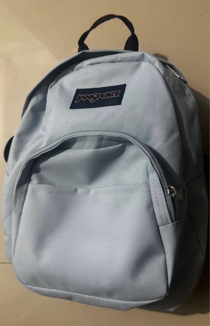 Jansport Mini Backpack - Light Blue (Category: Backpacks) located in Manila. Submitted by xxxmjayne (Listing ID 1420476495, Image 3). Description: - Light blue Jansport mini backpack - Main compartment - Front zippered pocket - Black straps - Top handle - Jansport logo visible - Mini size, ideal for daily essentials.