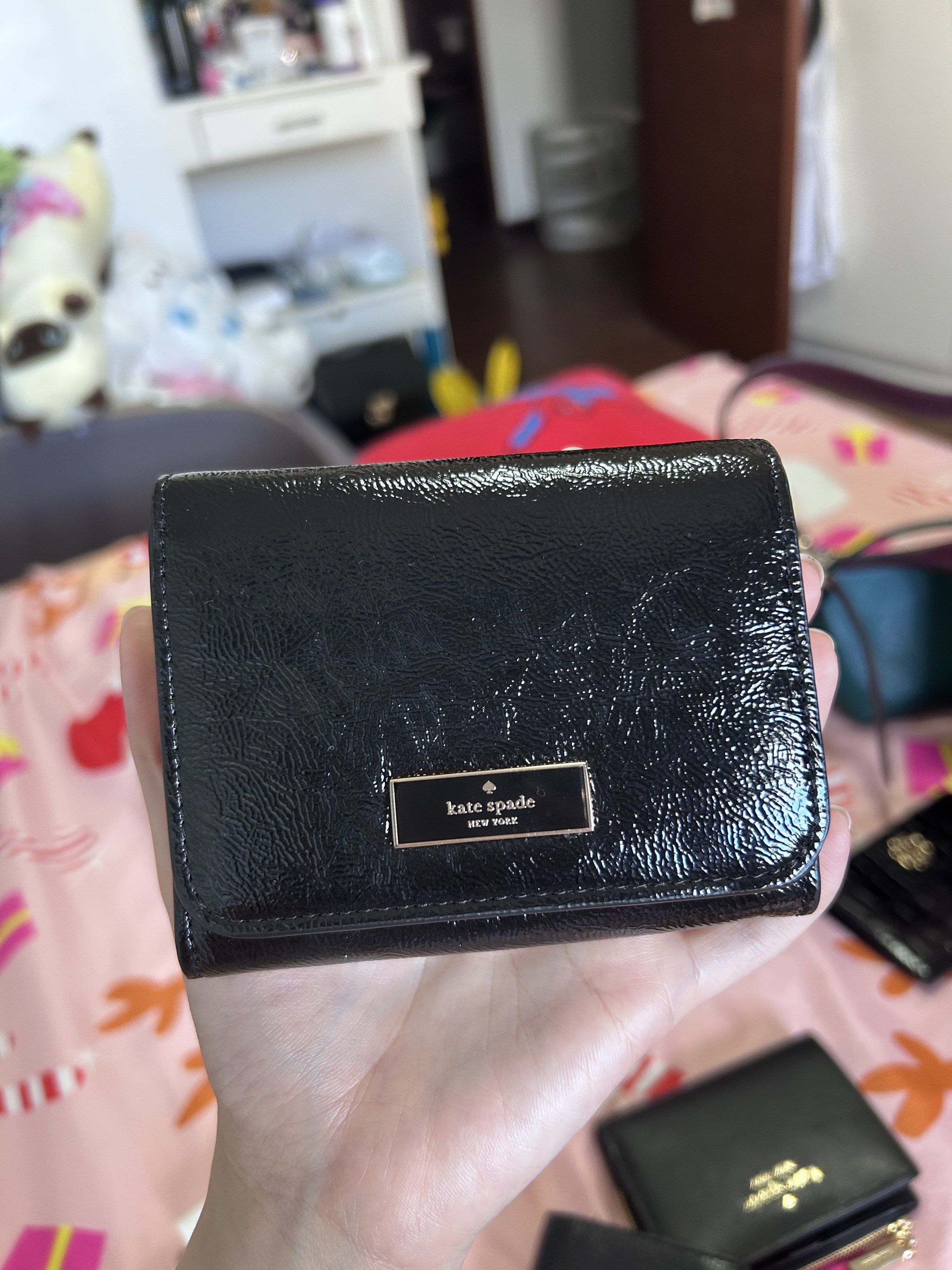 Kate Spade Black Crinkle Patent Wallet (Category: Luxury Bags & Wallets) located in Muntinlupa City. Submitted by piayo (Listing ID 1420419540, Image 1). Description: - Authentic Kate Spade wallet - Black crinkle patent leather - Snap closure - Zippered coin compartment - Multiple card slots - Bill compartment - Kate Spade New York logo embossed inside - Brand new with original price tag.