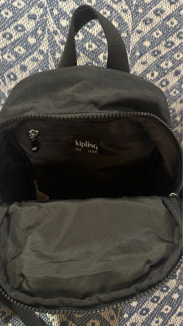 Kipling Zinna Backpack - Black (Category: Backpacks) located in Caloocan City. Submitted by cyy.declutter (Listing ID 1420395729, Image 3). Description: Authentic Kipling Zinna backpack Measurements: 7.75”W x 4”H x 11”D Color: Black Features: - Front zippered pocket - Main compartment with Kipling logo - Adjustable straps - Top handle - Includes small keychain accessory - Brand new with original tags - Still in original packaging SRP: 7,500 RFS: 