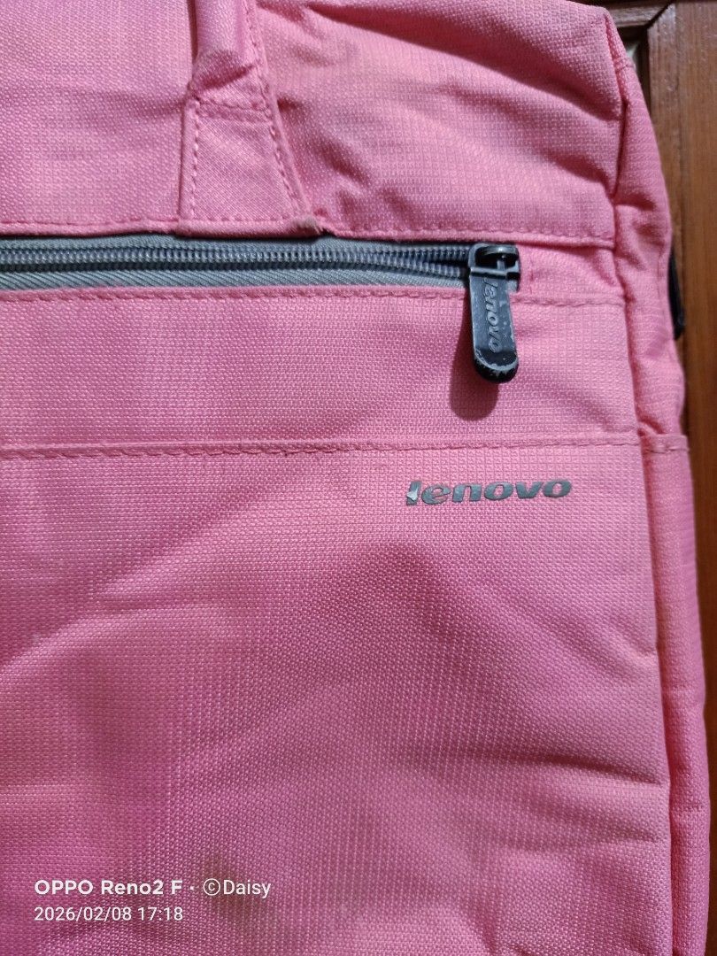 Lenovo Pink Laptop Bag (Category: Laptop Bags & Sleeves) located in Quezon City. Submitted by daisyuy1979 (Listing ID 1420453343, Image 2). Description: - Pink Lenovo laptop bag - Top handle and shoulder strap - Main compartment with zipper closure - Additional front pocket - Dark grey interior lining - Lenovo logo on the front.
