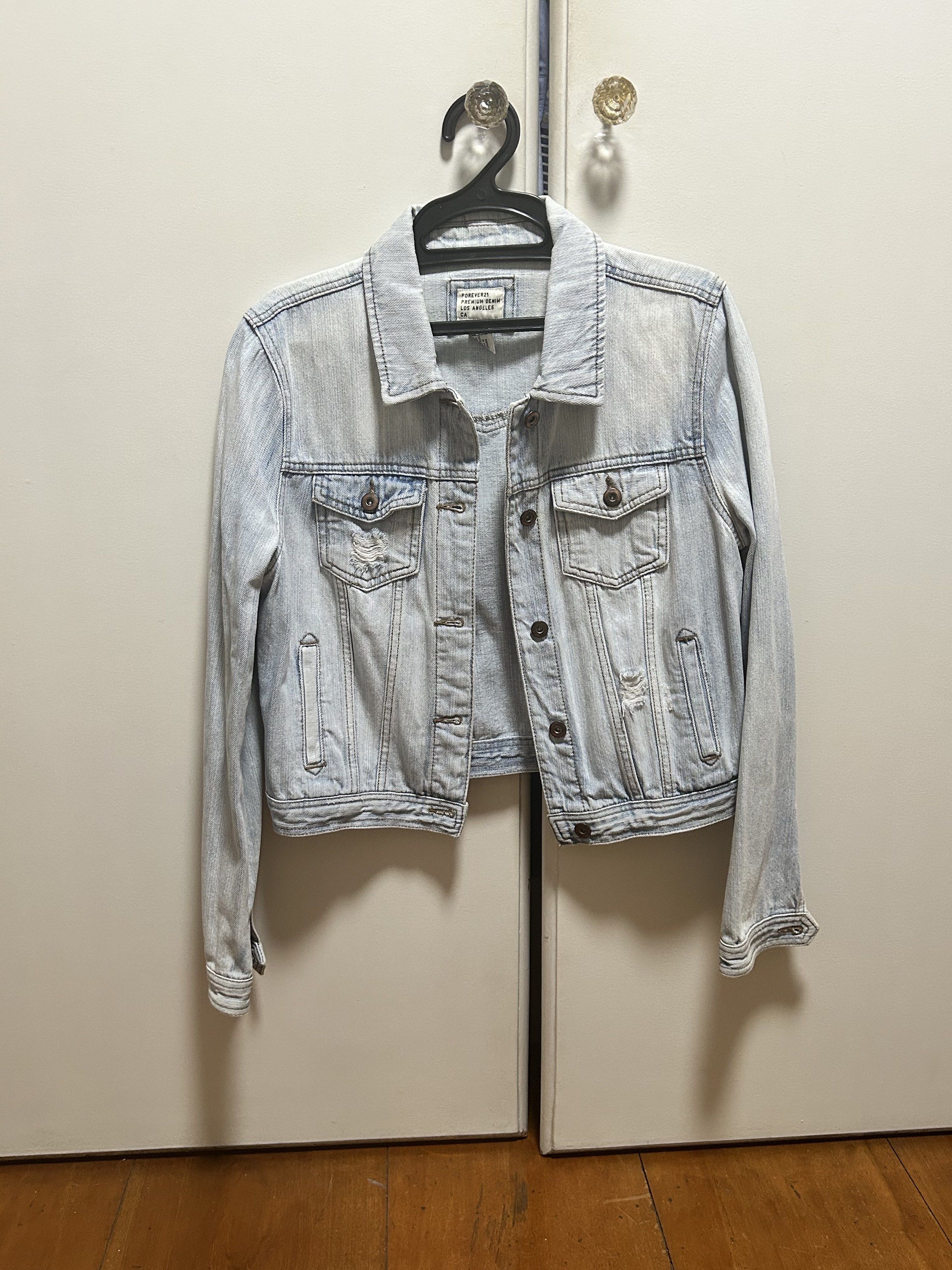 Light Wash Denim Jacket (Category: Coats, Jackets and Outerwear) located in Marikina City. Submitted by mfdecluttering (Listing ID 1420535475, Image 1). Description: - Light wash denim jacket - Button closure - Features two chest pockets and two side pockets - Classic collar and long sleeves - Unique yoke detail on the back - Distressed denim - Perfect for layering.