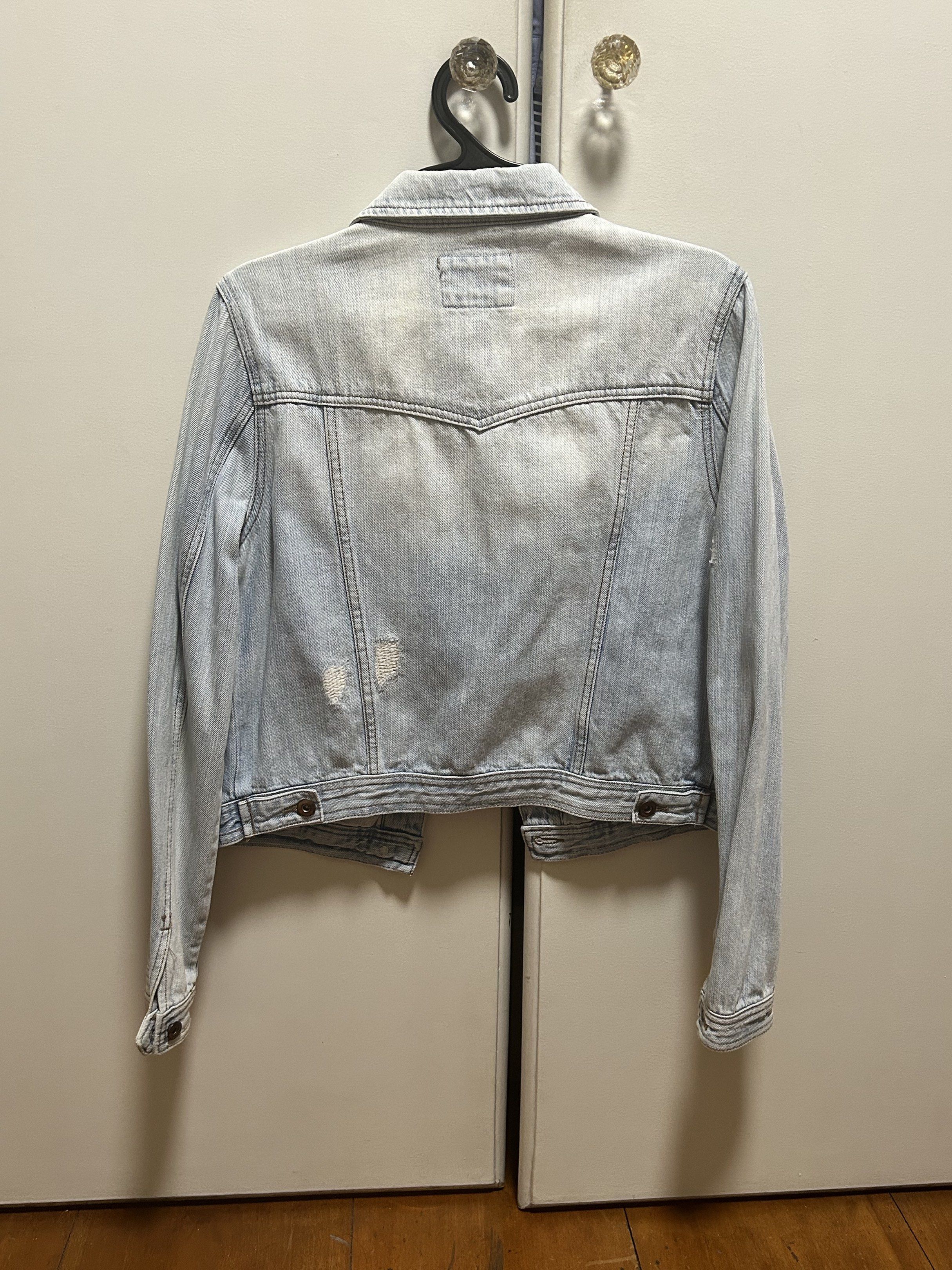 Light Wash Denim Jacket (Category: Coats, Jackets and Outerwear) located in Marikina City. Submitted by mfdecluttering (Listing ID 1420535475, Image 2). Description: - Light wash denim jacket - Button closure - Features two chest pockets and two side pockets - Classic collar and long sleeves - Unique yoke detail on the back - Distressed denim - Perfect for layering.