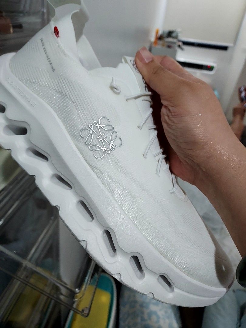 Loewe x On Cloudtilt All White Sneakers (Category: Sneakers) located in Paranaque City. Submitted by andim8 (Listing ID 1420435176, Image 3). Description: - Loewe x On Cloudtilt sneakers - All-white colorway - Size 41 - Features Loewe logo - Includes original box, extra laces, and dust bag - Unique sole design - Unworn condition bnew bought from Loewe stor in Ion Orchard never used complete with box dustbags and extra shoelace fits womens 9.5 to 