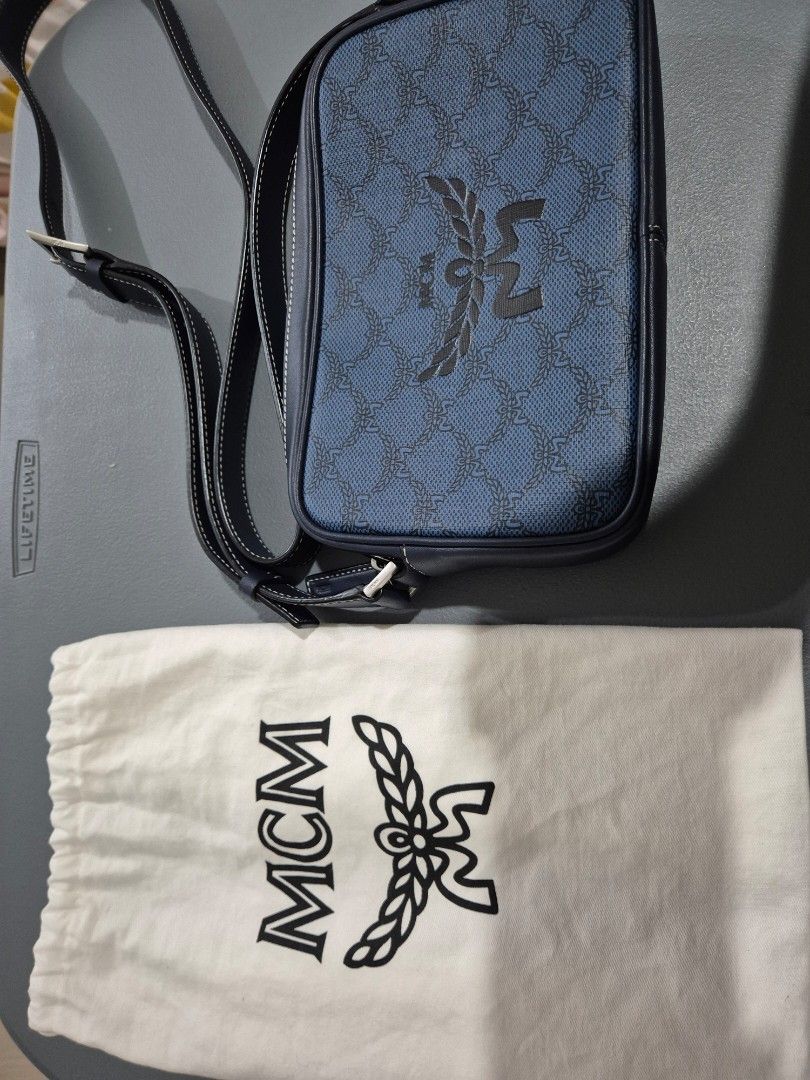 MCM Blue Crossbody Bag (Category: Luxury Bags & Wallets) located in Cabuyao City. Submitted by AR700 (Listing ID 1420472758, Image 2). Description: - Authentic MCM crossbody bag - Blue monogram pattern - Includes dust bag, authenticity card, and original packaging, paperbag - Interior with card slots and compartments - Adjustable shoulder strap - Secure zipper closure - Iconic MCM logo on the front Used a few times bought for 26k in SG sf c/o sel