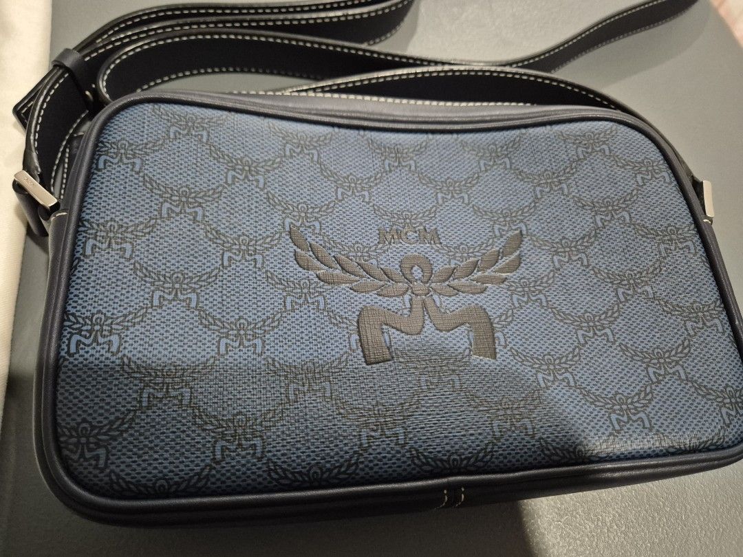 MCM Blue Crossbody Bag (Category: Luxury Bags & Wallets) located in Cabuyao City. Submitted by AR700 (Listing ID 1420472758, Image 1). Description: - Authentic MCM crossbody bag - Blue monogram pattern - Includes dust bag, authenticity card, and original packaging, paperbag - Interior with card slots and compartments - Adjustable shoulder strap - Secure zipper closure - Iconic MCM logo on the front Used a few times bought for 26k in SG sf c/o sel