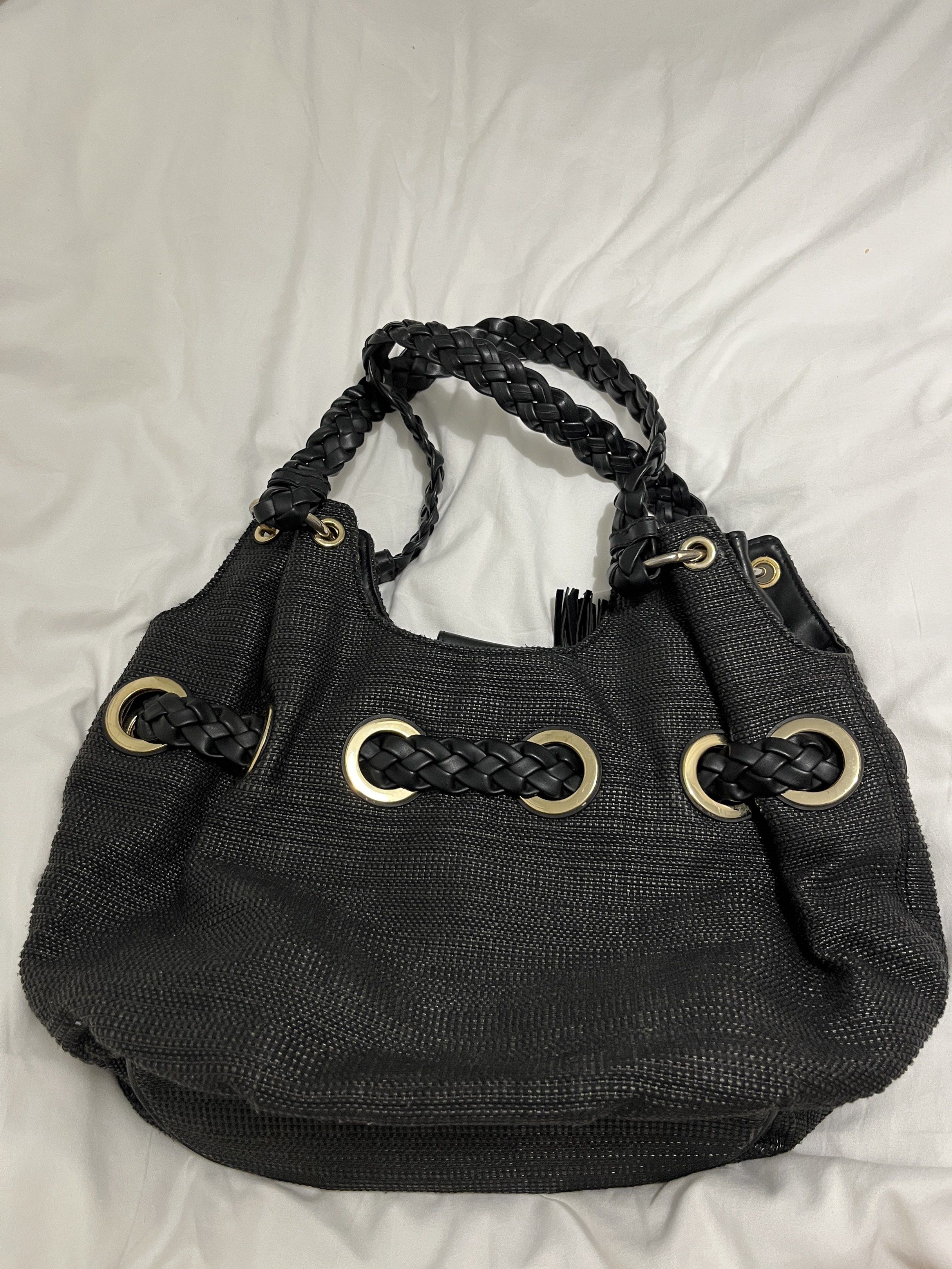 Michael Kors Black Hobo Bag (Category: Luxury Bags & Wallets) located in San Jose del Monte. Submitted by cindy7711 (Listing ID 1420438558, Image 2). Description: - Authentic Michael Kors hobo bag - Color: Black - Braided handles - Gold-tone hardware - Main compartment with magnetic snap closure - Interior zip pocket - MK logo lining - Woven exterior - Tassel detail.