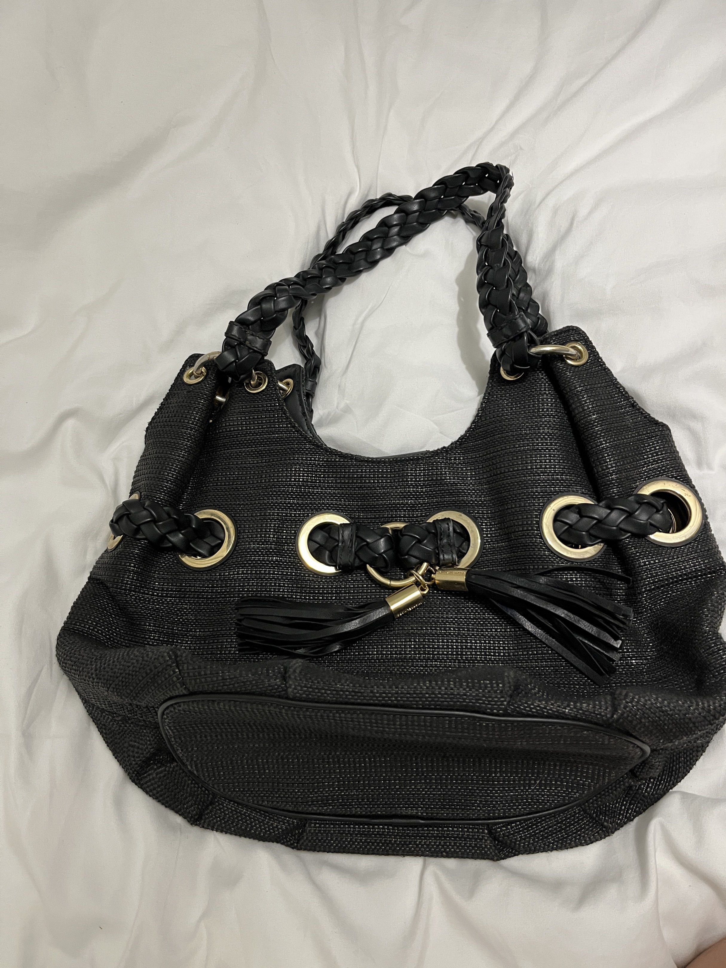 Michael Kors Black Hobo Bag (Category: Luxury Bags & Wallets) located in San Jose del Monte. Submitted by cindy7711 (Listing ID 1420438558, Image 1). Description: - Authentic Michael Kors hobo bag - Color: Black - Braided handles - Gold-tone hardware - Main compartment with magnetic snap closure - Interior zip pocket - MK logo lining - Woven exterior - Tassel detail.