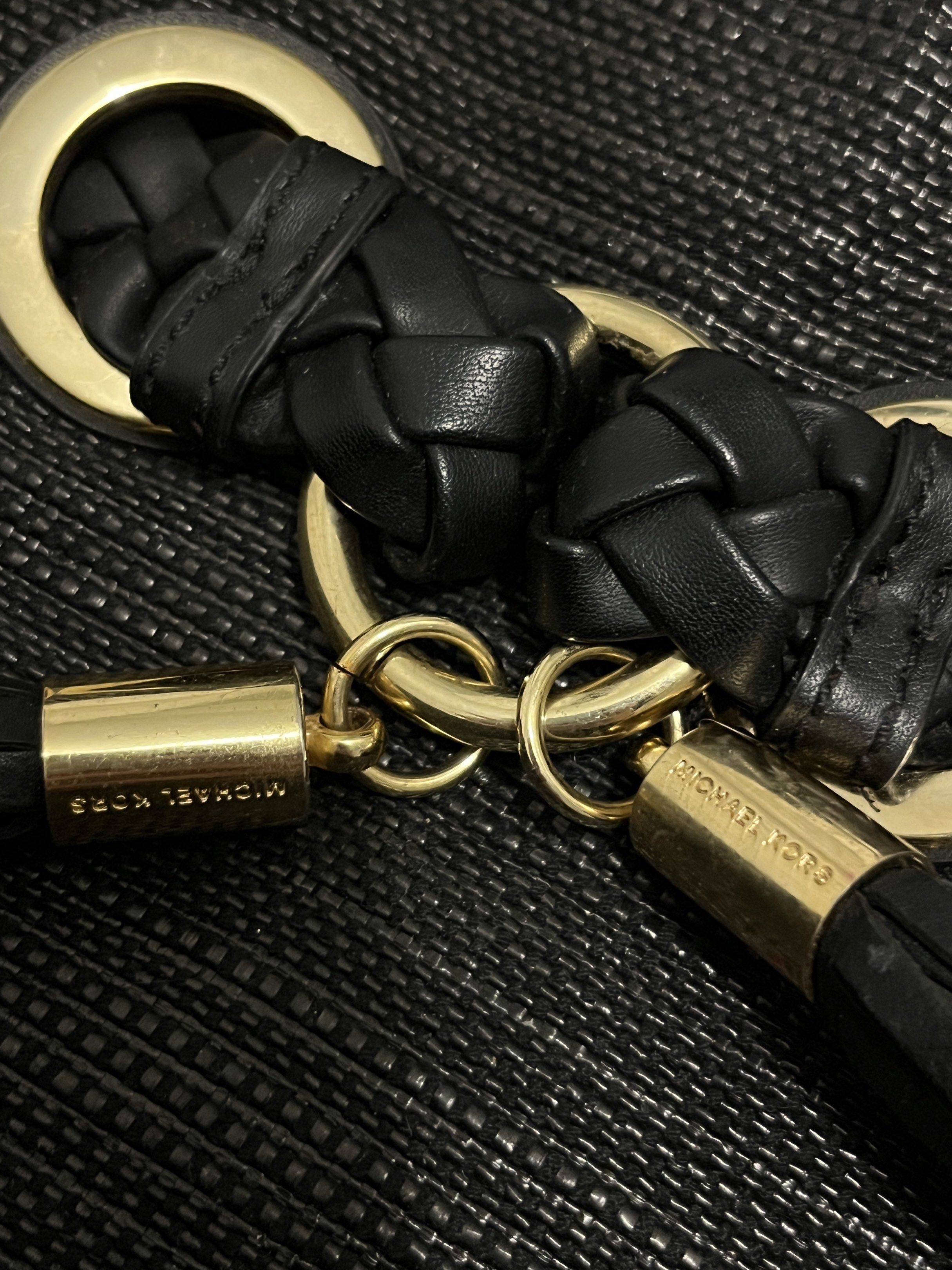 Michael Kors Black Hobo Bag (Category: Luxury Bags & Wallets) located in San Jose del Monte. Submitted by cindy7711 (Listing ID 1420438558, Image 3). Description: - Authentic Michael Kors hobo bag - Color: Black - Braided handles - Gold-tone hardware - Main compartment with magnetic snap closure - Interior zip pocket - MK logo lining - Woven exterior - Tassel detail.