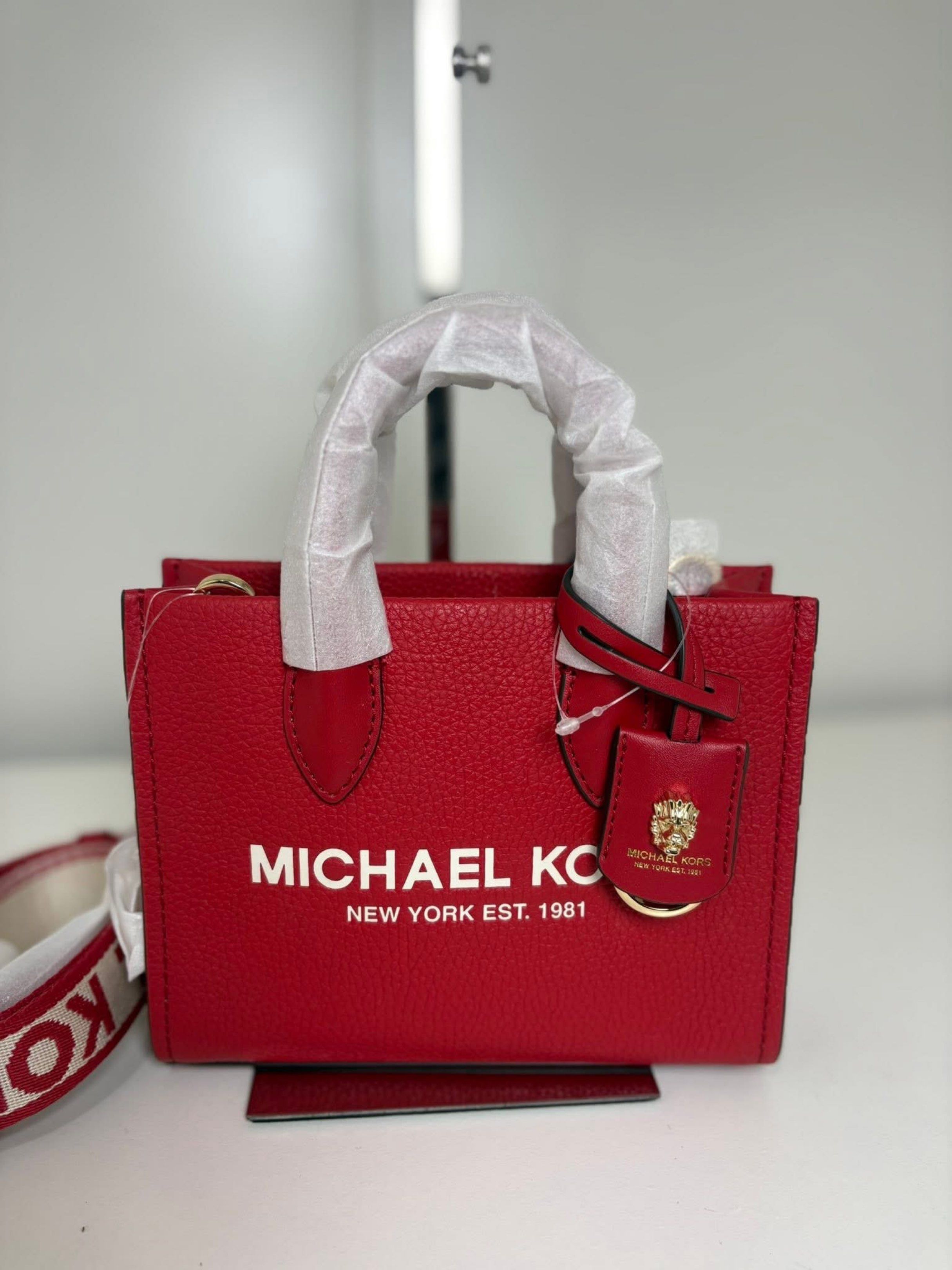 Michael Kors Red Tote Bag (Category: Luxury Bags & Wallets) located in Manila. Submitted by lovieauthenticmerchandise (Listing ID 1420492811, Image 1). Description: - Authentic Michael Kors tote bag - Vibrant red color - Top handle and detachable shoulder strap - Features the iconic Michael Kors logo - Compact size, ideal for everyday use.
