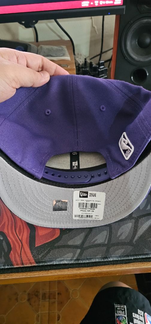 New Era 9Fifty Phoenix Suns Snapback Cap (Category: Caps & Hats) located in Pasay City. Submitted by bs_flatline (Listing ID 1420404916, Image 3). Description: - Official New Era 9Fifty cap - Phoenix Suns logo - Color: Purple with grey underbrim - NBA logo on the side - Adjustable snapback closure - Original New Era tag attached Bnew as displayed only on Shop. NO box. Cap only.