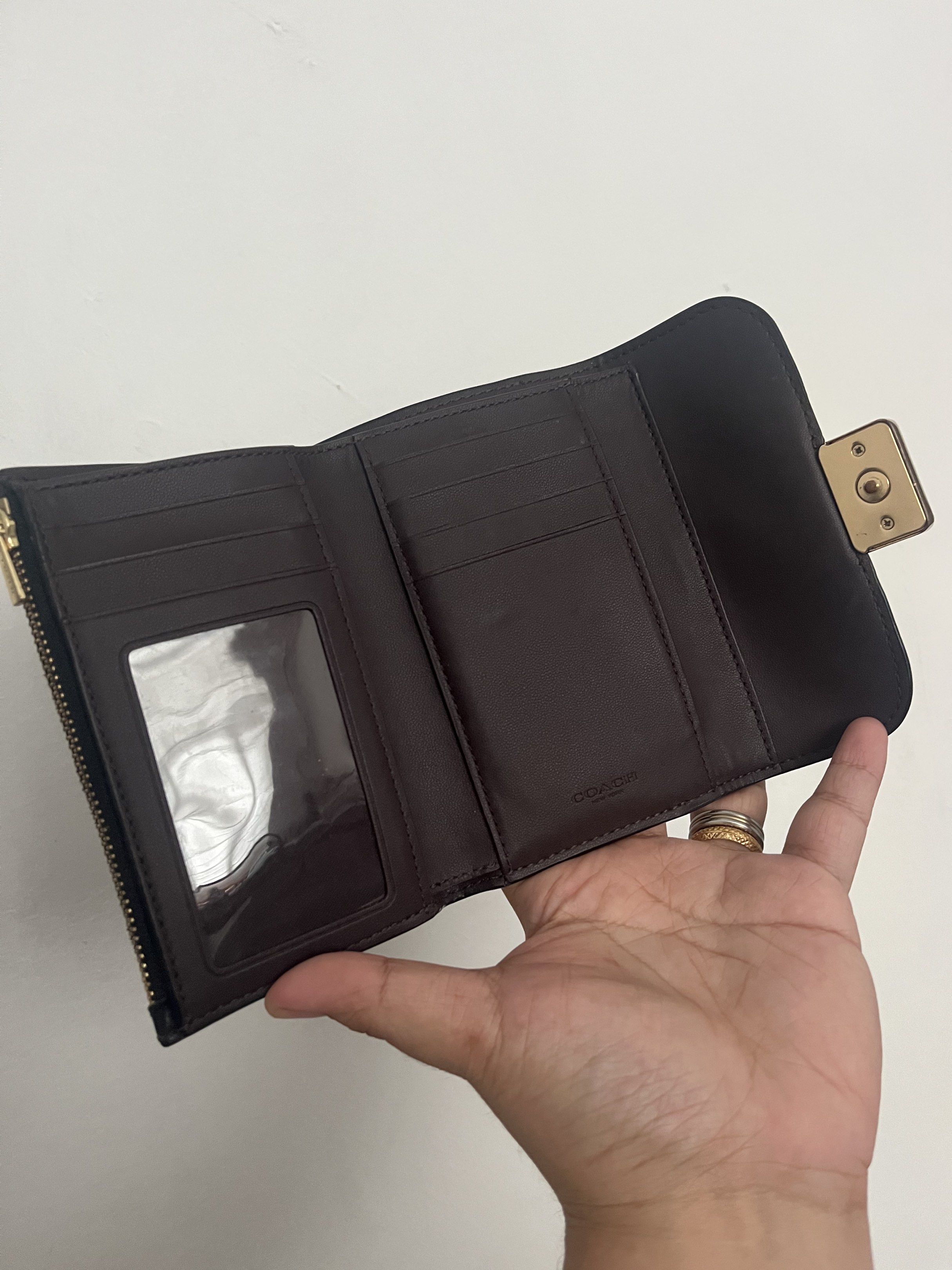 Pebbled Coach Medium Grace Wallet CC059 (Category: Luxury Bags & Wallets) located in Las Pinas. Submitted by handydandy.eg (Listing ID 1420387187, Image 2). Description: Gorgeous Coach Medium Grace Wallet in classic black pebbled leather. Its interior leather is dark burgundy/maroon. Features 1 paper bill compartment, at least 8 card slots, 1 id/photo insert, 1 zipper pocket, and 1 back slot. Closure is snap button. No major flaws, even the rubbe