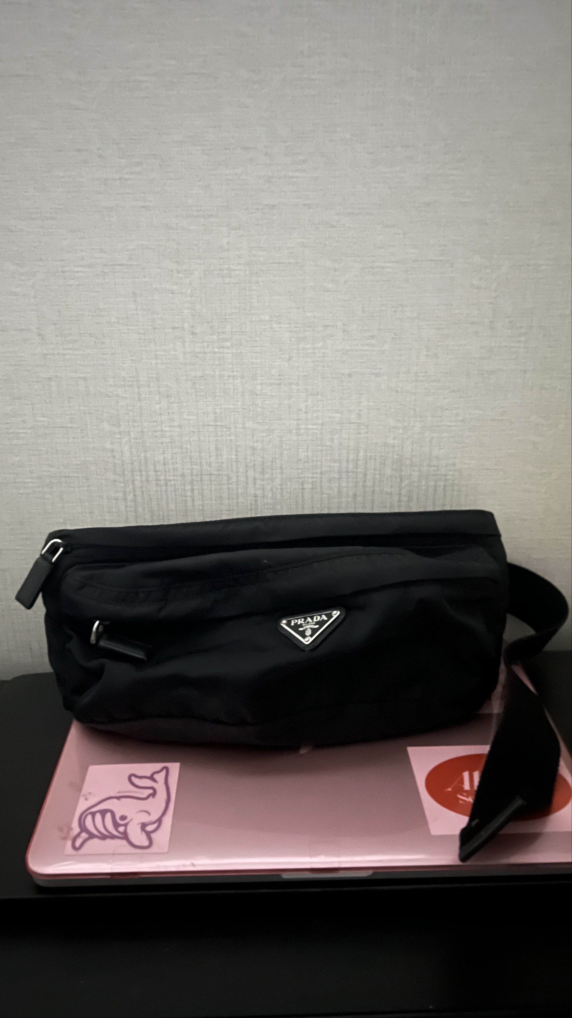 REPRICED Prada Black Belt Bag (Category: Luxury Bags & Wallets) located in Manila. Submitted by fitmeph (Listing ID 1420497431, Image 1). Description: - Authentic Prada waist bag - Color: Black - Material: Nylon - Features: - Main zippered compartment - Adjustable strap - Prada logo - Wear it around the waist or crossbody.