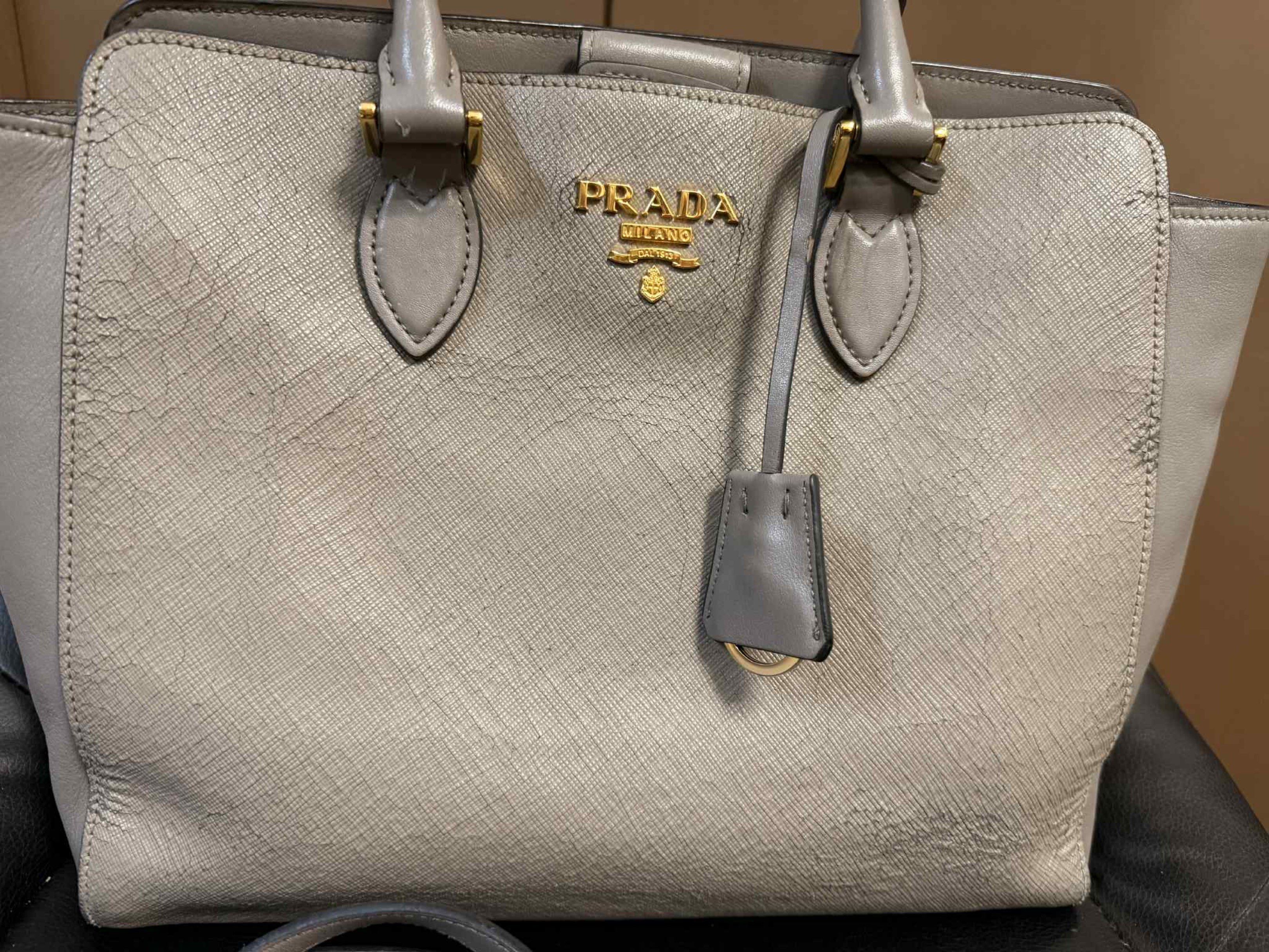 Prada Saffiano Leather Handbag 2 WAY BAG (Category: Luxury Bags & Wallets) located in Marilao. Submitted by vhi3yhn (Listing ID 1420495185, Image 2). Description: Prada handbag 2 WAY BAG ORIGINAL ‼️ - Grey Saffiano leather exterior - Gold-tone hardware - Detachable shoulder strap - Top handles - Fabric-lined interior with multiple compartments - Prada logo on front note: may konting bakbak po kaya bigay na lang ng mura.