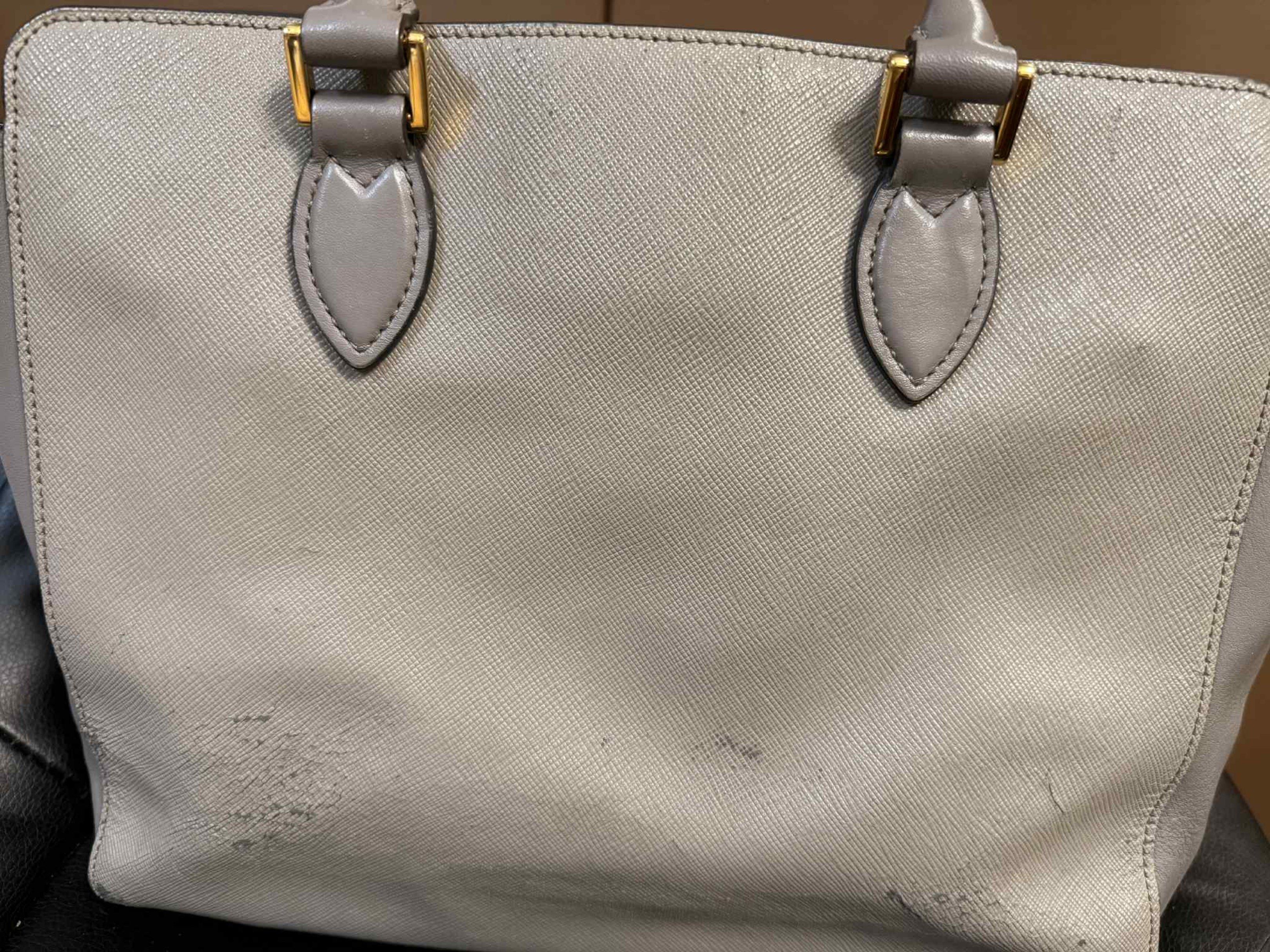 Prada Saffiano Leather Handbag 2 WAY BAG (Category: Luxury Bags & Wallets) located in Marilao. Submitted by vhi3yhn (Listing ID 1420495185, Image 3). Description: Prada handbag 2 WAY BAG ORIGINAL ‼️ - Grey Saffiano leather exterior - Gold-tone hardware - Detachable shoulder strap - Top handles - Fabric-lined interior with multiple compartments - Prada logo on front note: may konting bakbak po kaya bigay na lang ng mura.