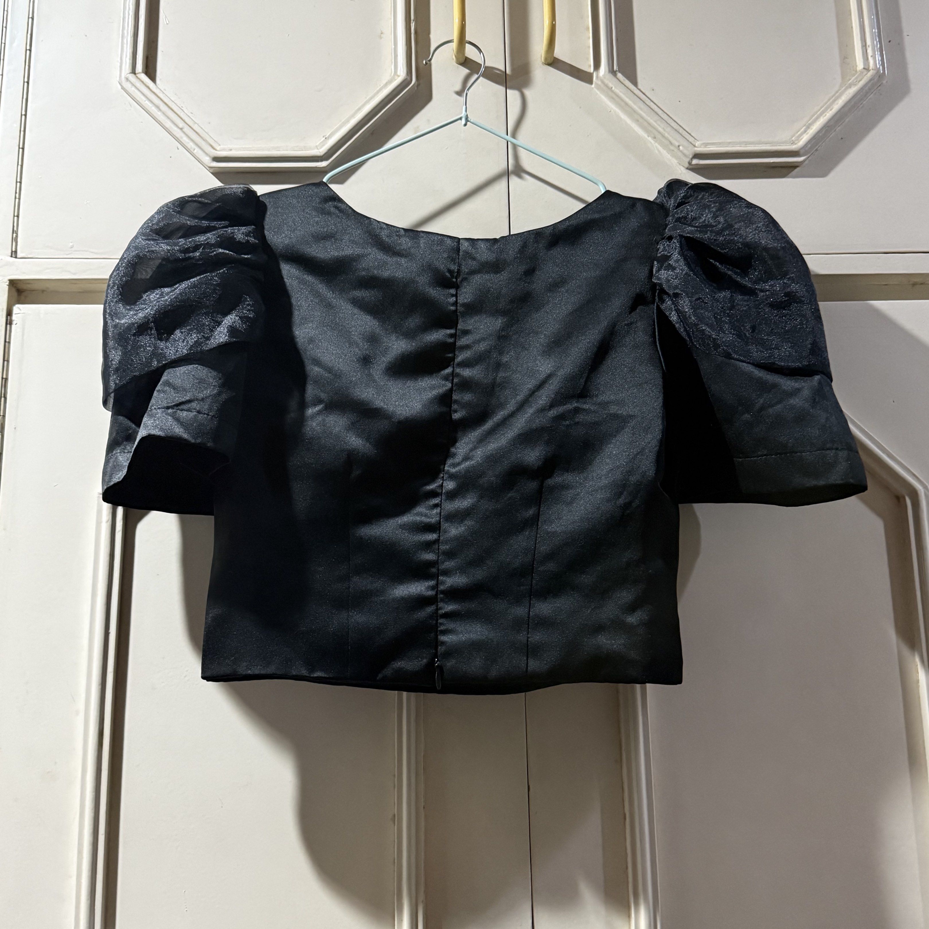 Preloved: Black Customized Modern Filipiniana Top (Category: Blouses) located in Antipolo. Submitted by bookcycledph (Listing ID 1420535971, Image 2). Description: - Black V-neck top - Short puff sleeves - Fabric with a slight sheen - Simple back design - Suitable for night outs and special occasions .