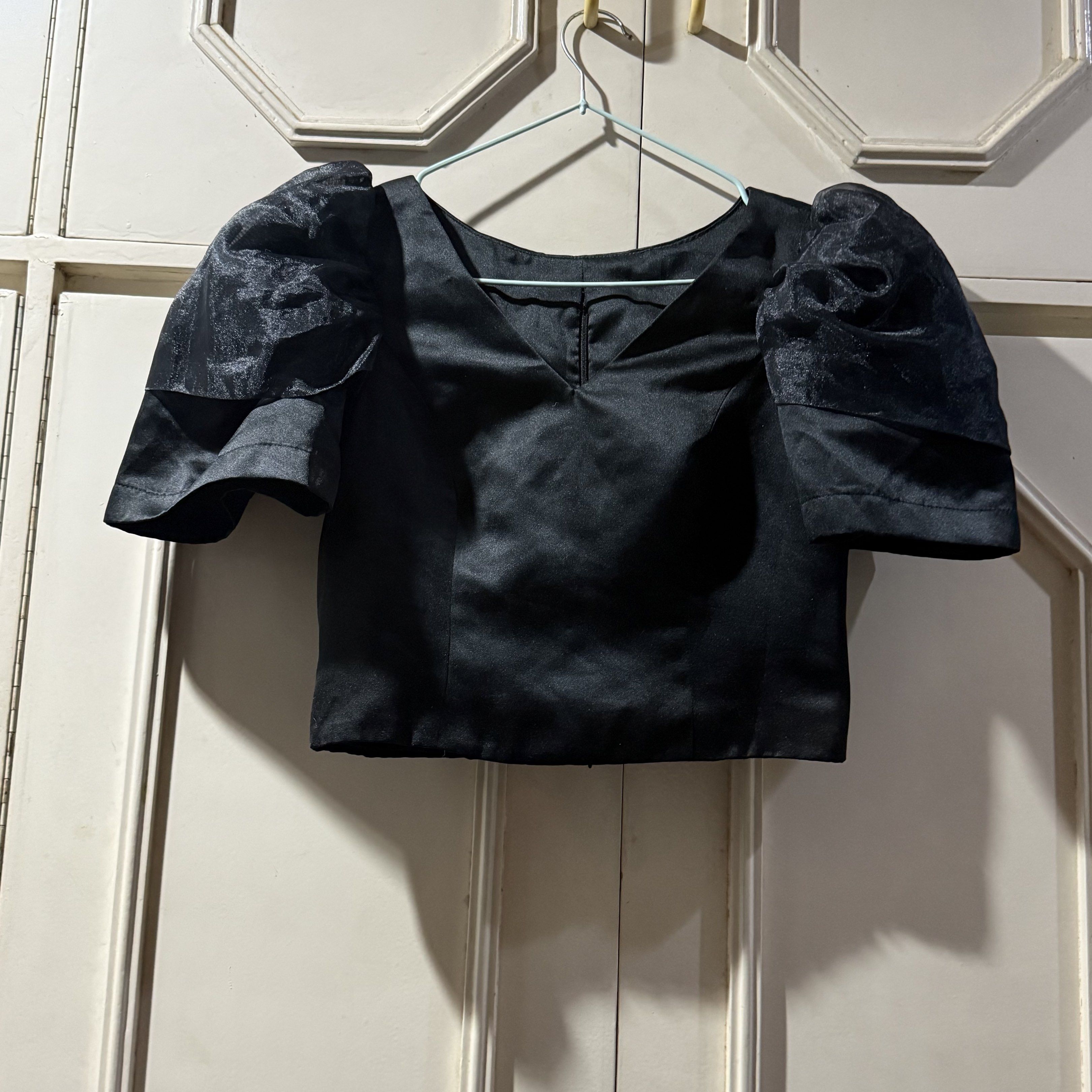 Preloved: Black Customized Modern Filipiniana Top (Category: Blouses) located in Antipolo. Submitted by bookcycledph (Listing ID 1420535971, Image 1). Description: - Black V-neck top - Short puff sleeves - Fabric with a slight sheen - Simple back design - Suitable for night outs and special occasions .