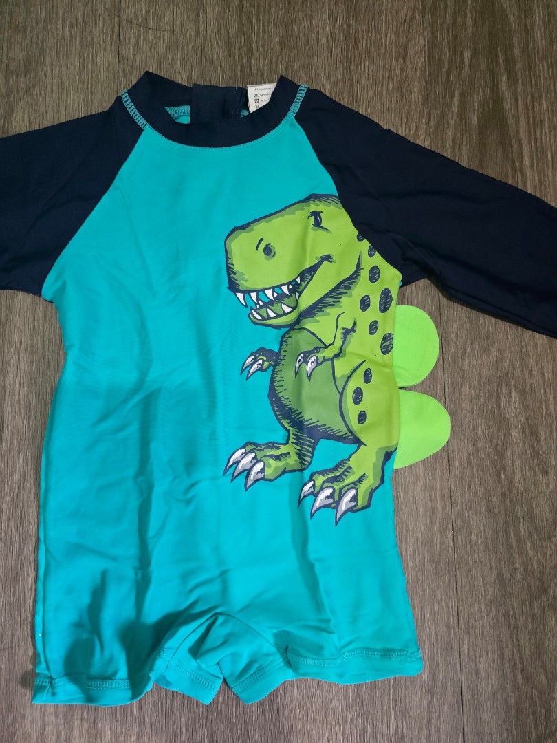 Sandbox Dinosaur Swimsuit rash guard (Category: Babies & Kids Fashion) located in Mandaluyong City. Submitted by ynahh (Listing ID 1420390425, Image 2). Description: - Sandbox dinosaur swimsuit - Teal and navy color scheme - Features a green dinosaur graphic - Long sleeves for sun protection - Convenient zip closure - Unique dinosaur tail detail at the back issue * nabungi lang po zipper sa likod konti but still can be used. pwede din palitan. us