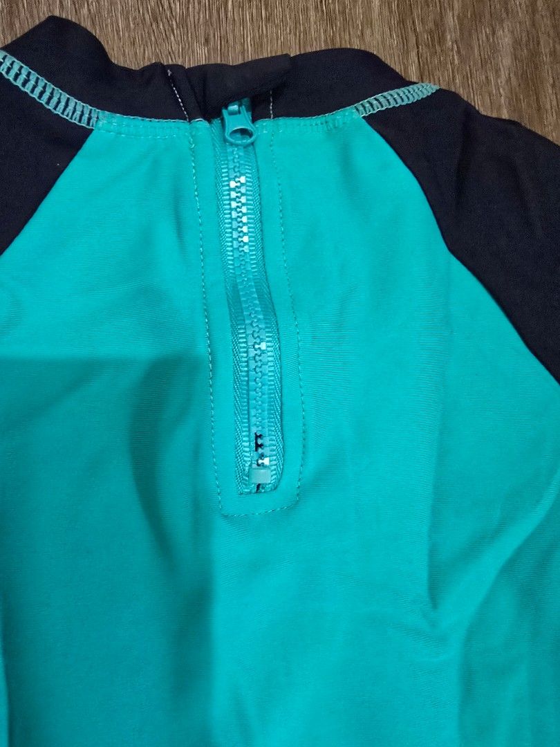 Sandbox Dinosaur Swimsuit rash guard (Category: Babies & Kids Fashion) located in Mandaluyong City. Submitted by ynahh (Listing ID 1420390425, Image 3). Description: - Sandbox dinosaur swimsuit - Teal and navy color scheme - Features a green dinosaur graphic - Long sleeves for sun protection - Convenient zip closure - Unique dinosaur tail detail at the back issue * nabungi lang po zipper sa likod konti but still can be used. pwede din palitan. us